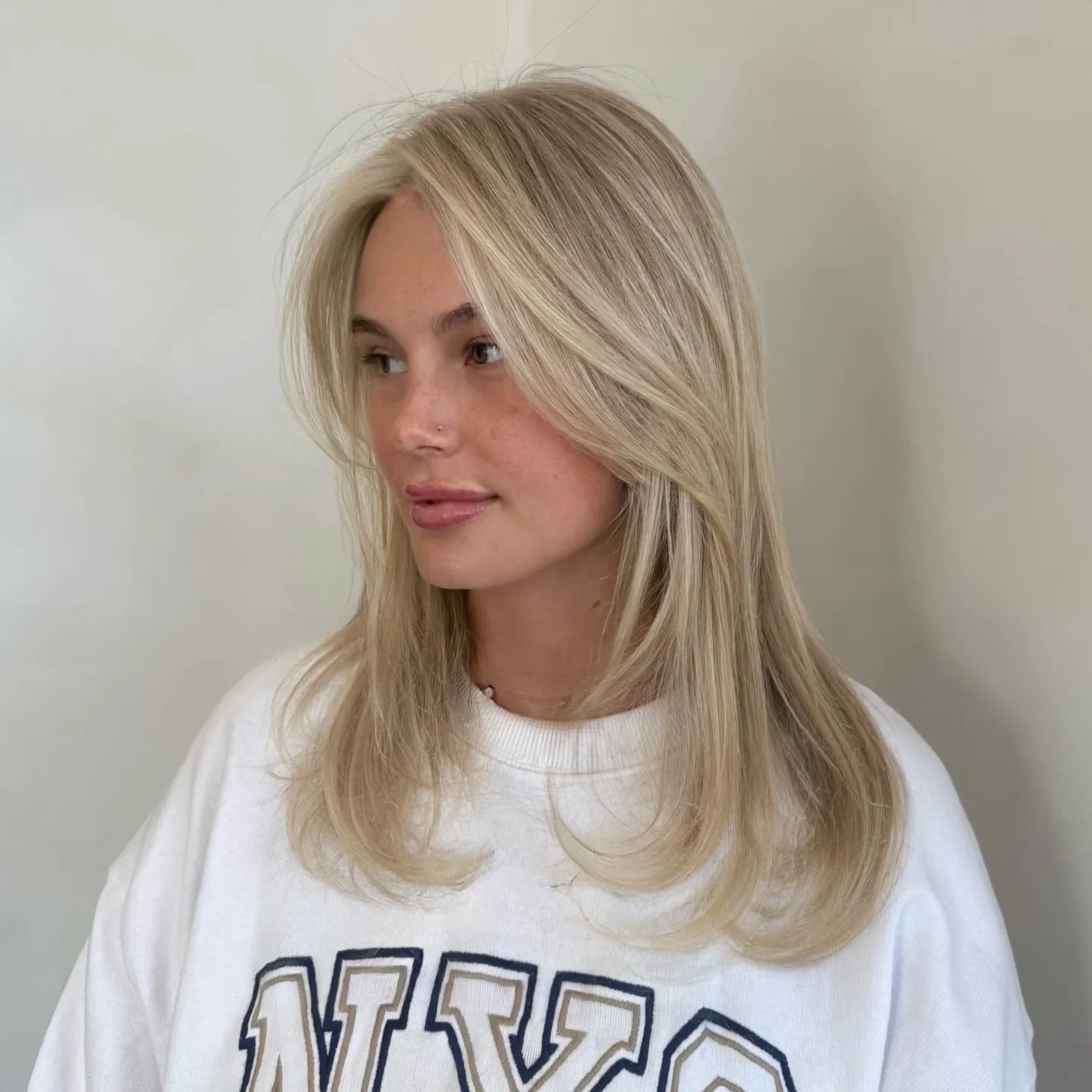 Straight baby blonde lob with curved ends