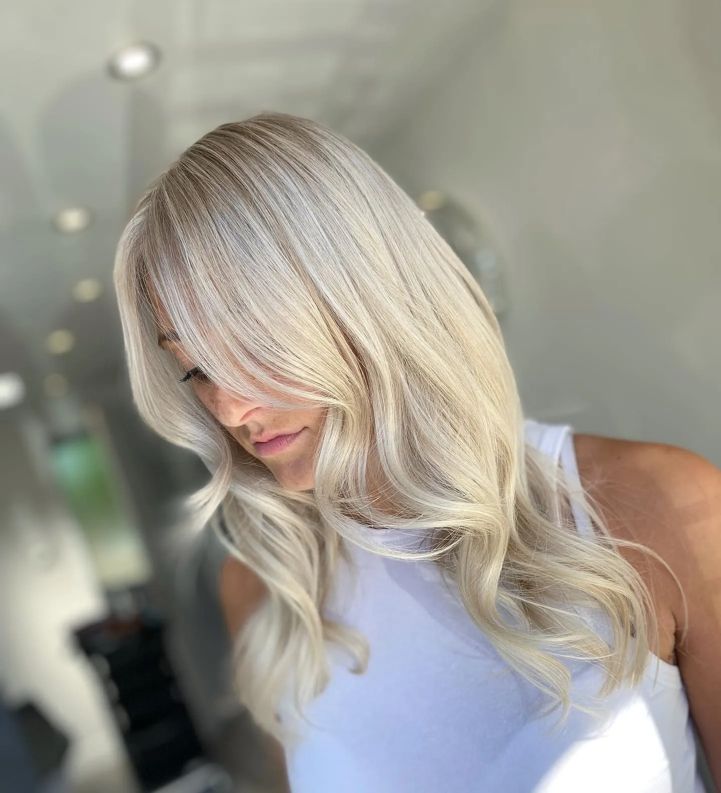 Layered baby blonde waves with side sweep