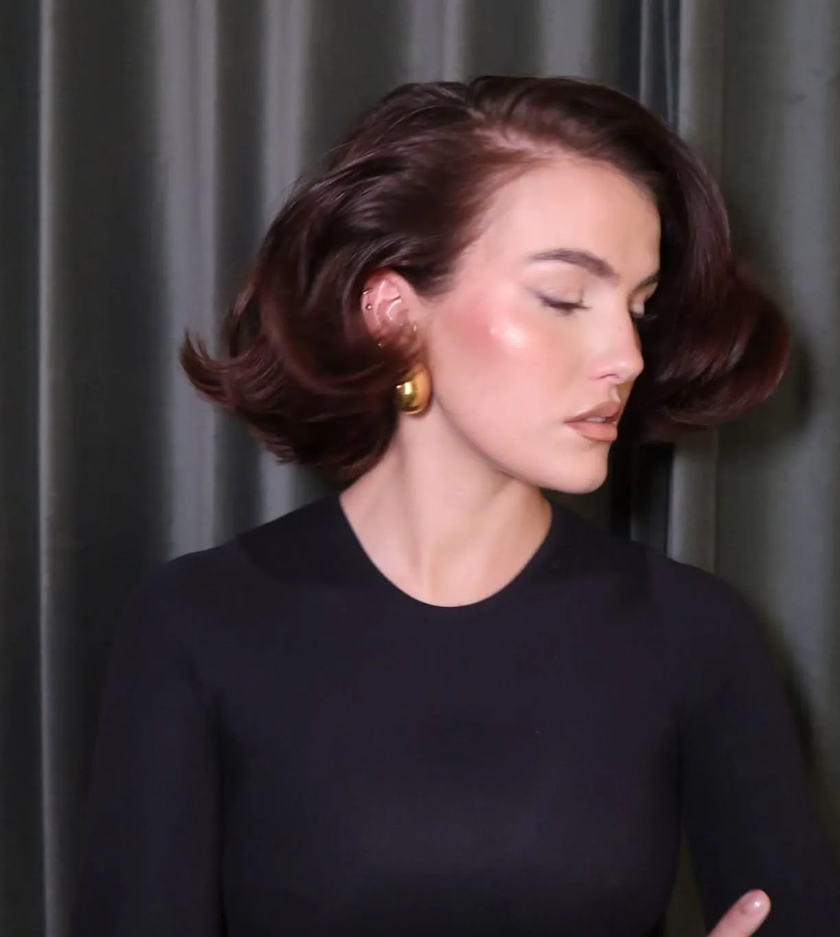 Dark red polished bob with side part and flipped ends