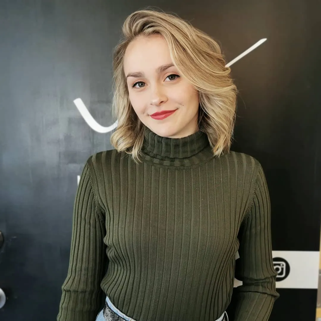 Layered blonde bob with soft side-swept waves