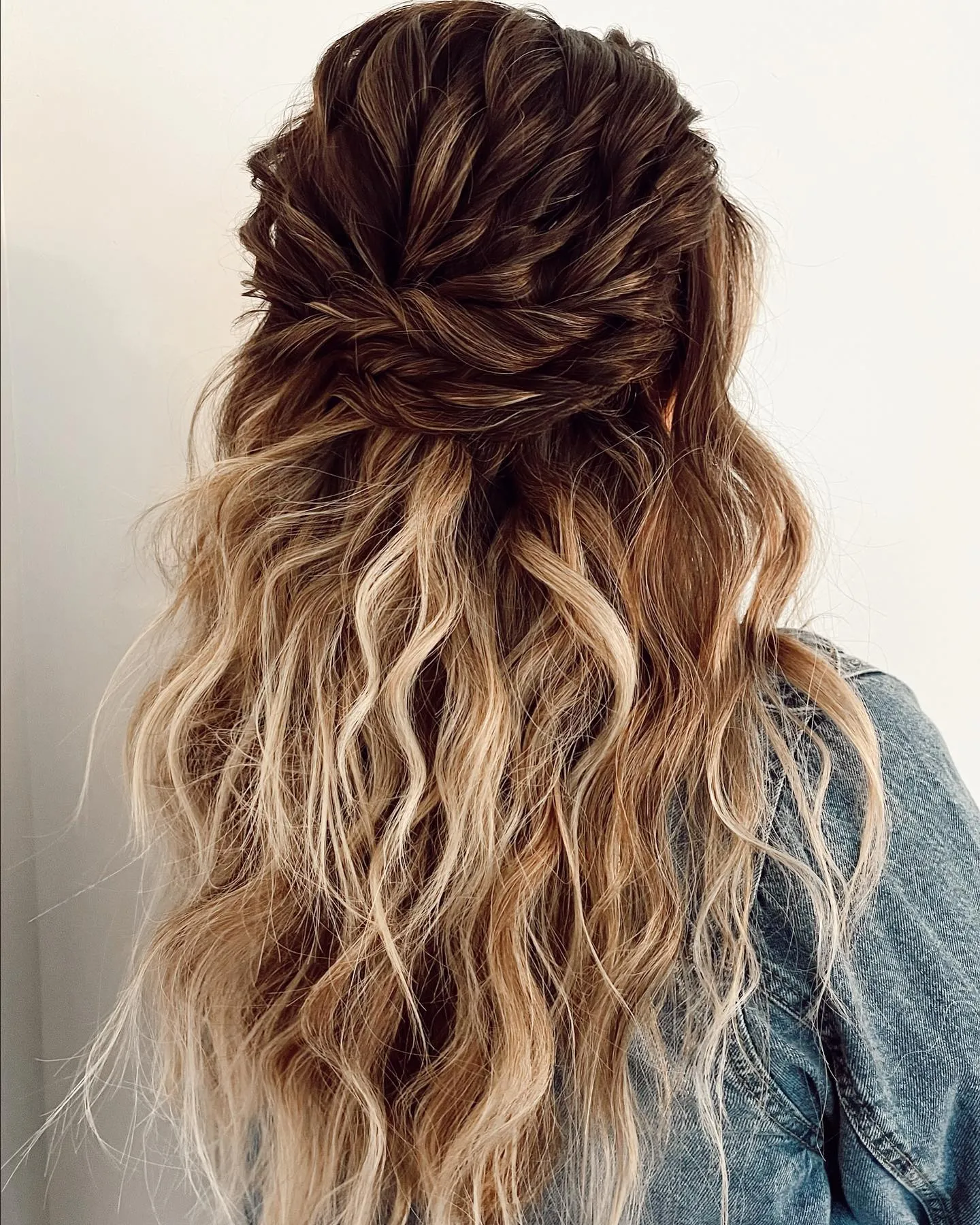 Twisted half-up hairstyle with long loose ombre waves