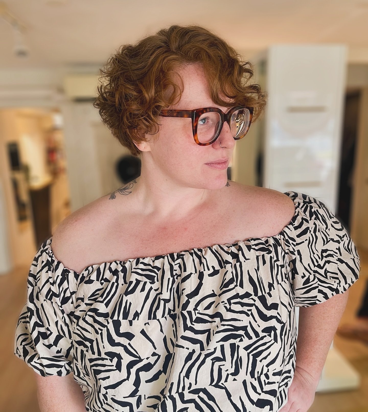 Short curly bixie with full rounded volume and defined ringlets