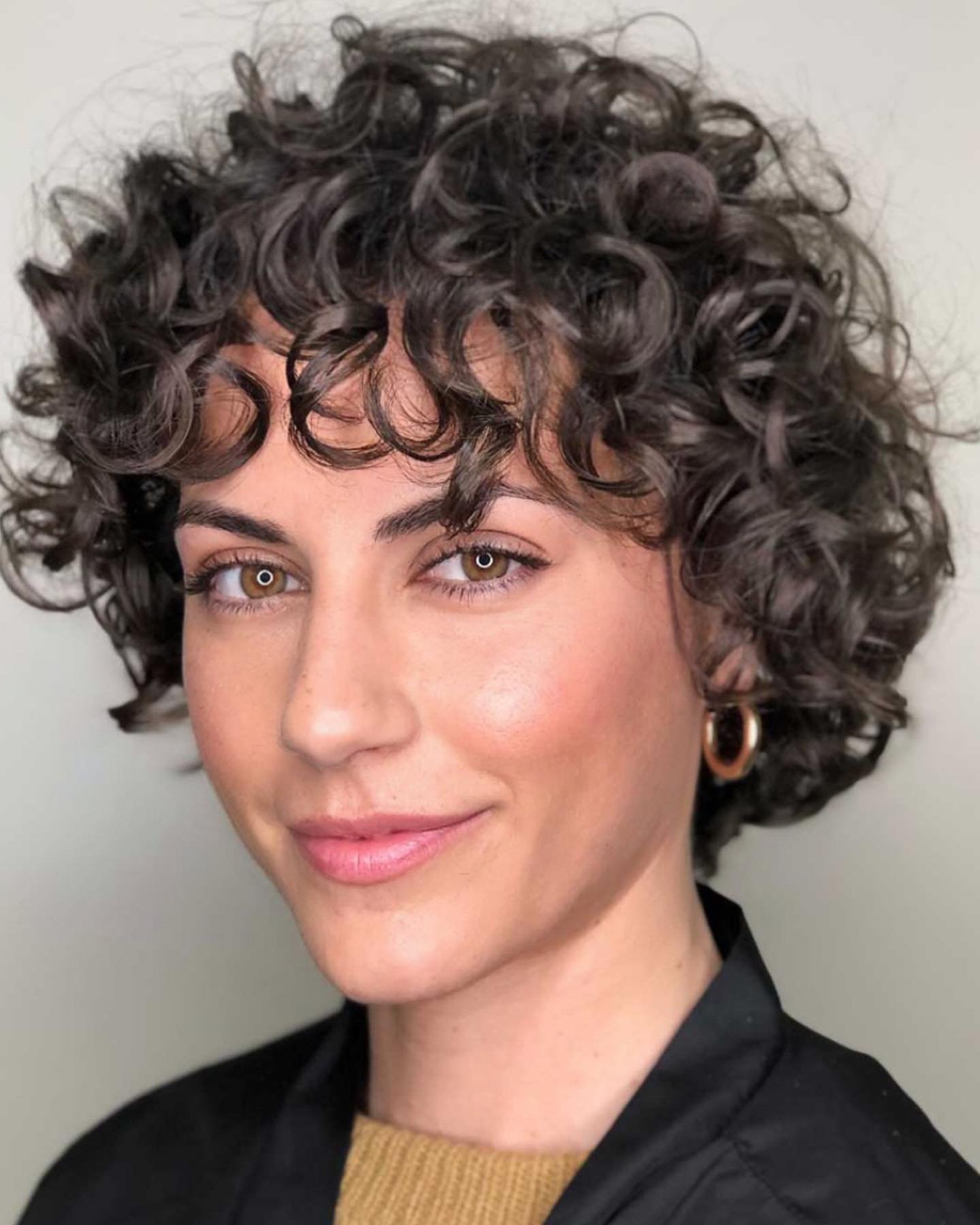 Rounded curly bixie with defined ringlets and a short curly fringe
