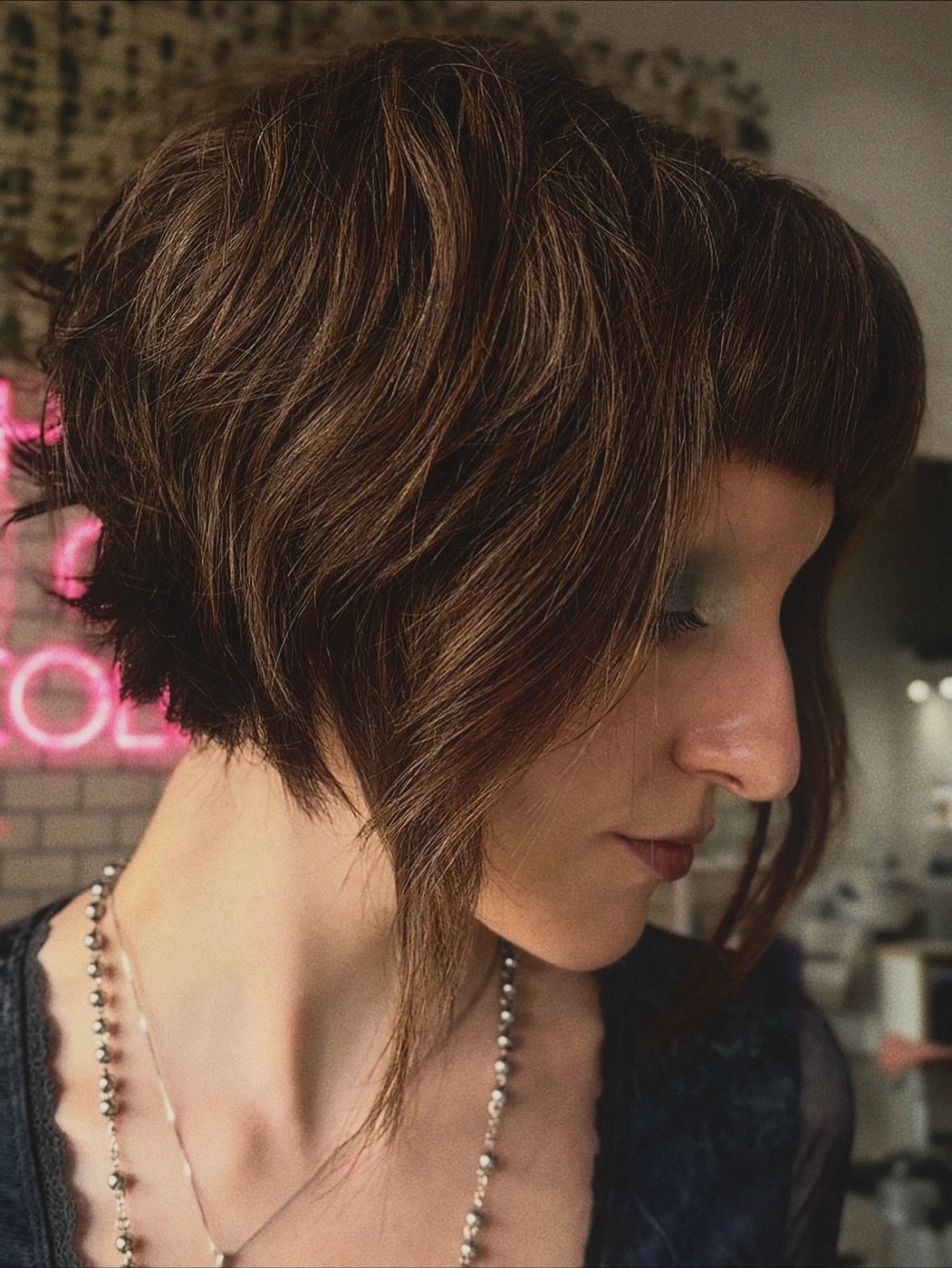 Angled layered bixie with a rounded back and long face-framing pieces