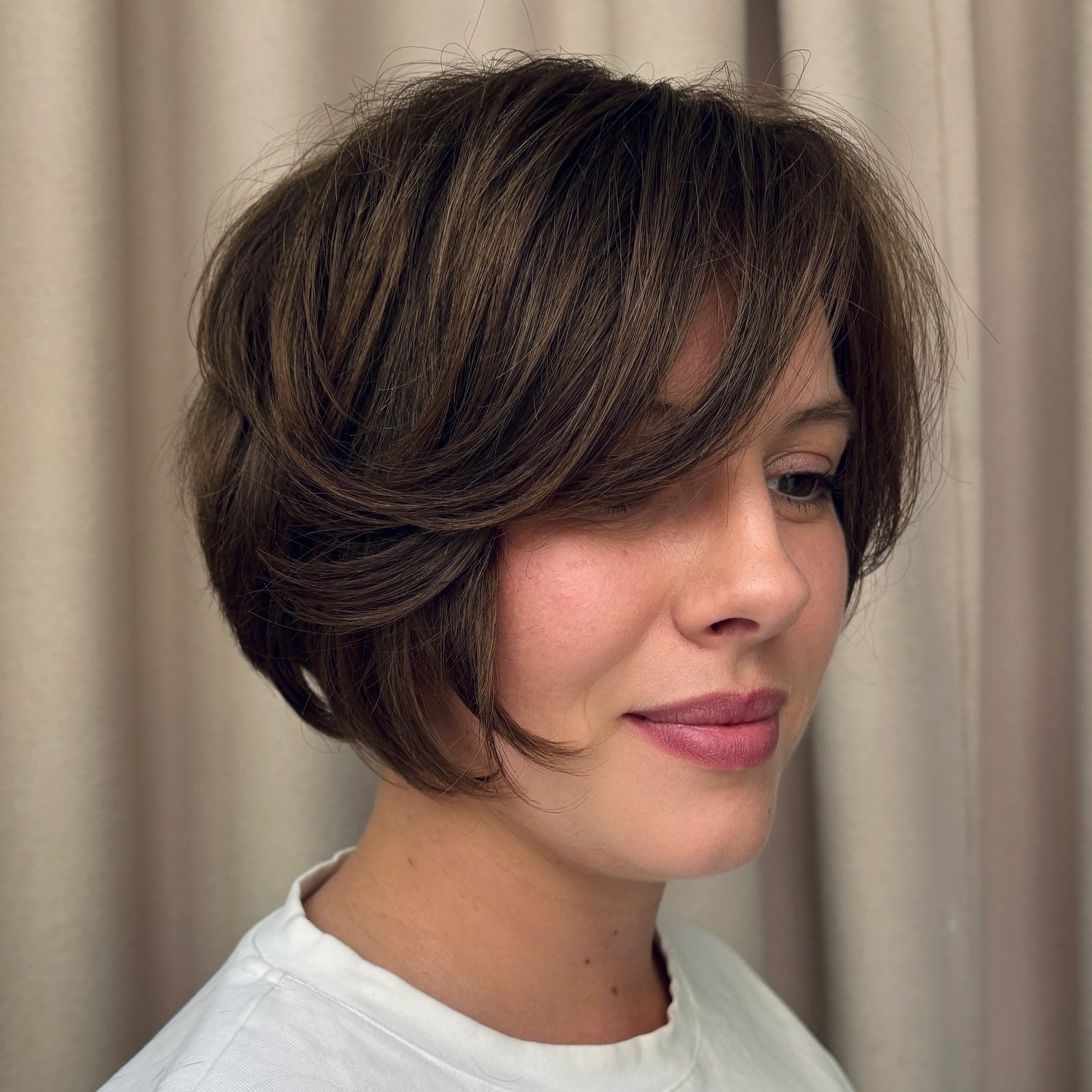 Polished rounded bixie with a curved side fringe and tucked neckline