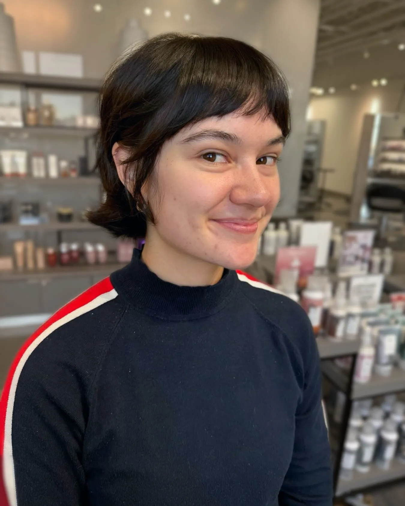Dark tucked bixie with short side-swept fringe