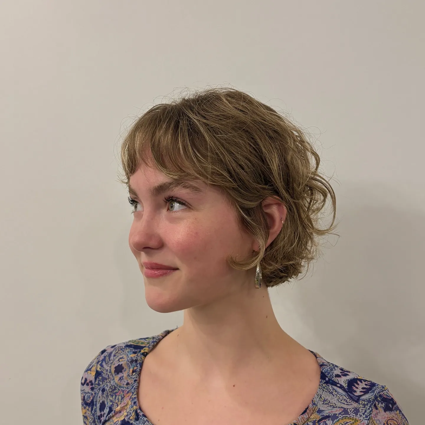 Wavy light brown bixie with soft fringe and curled ends