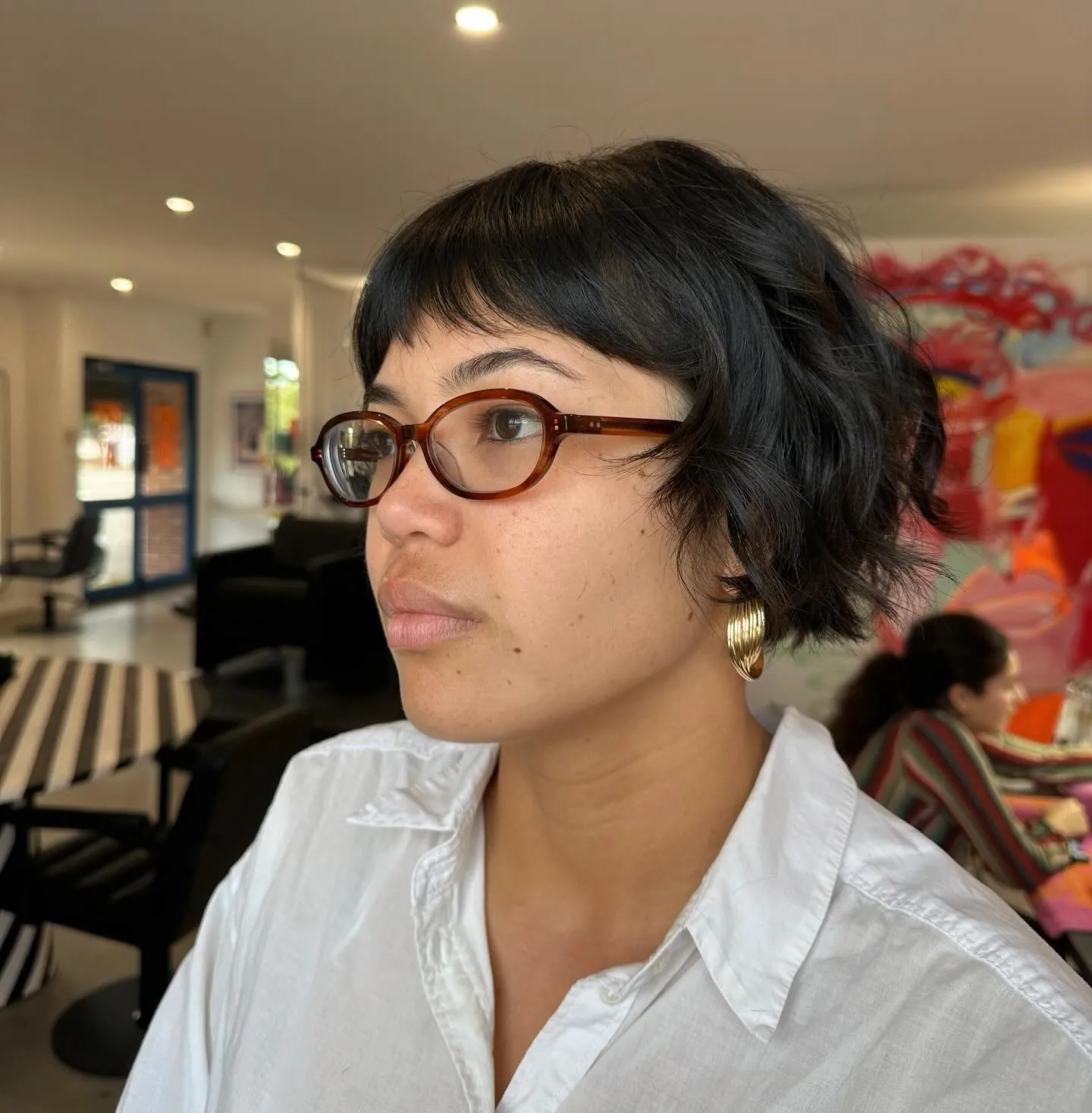 Wavy black bixie with short wispy fringe