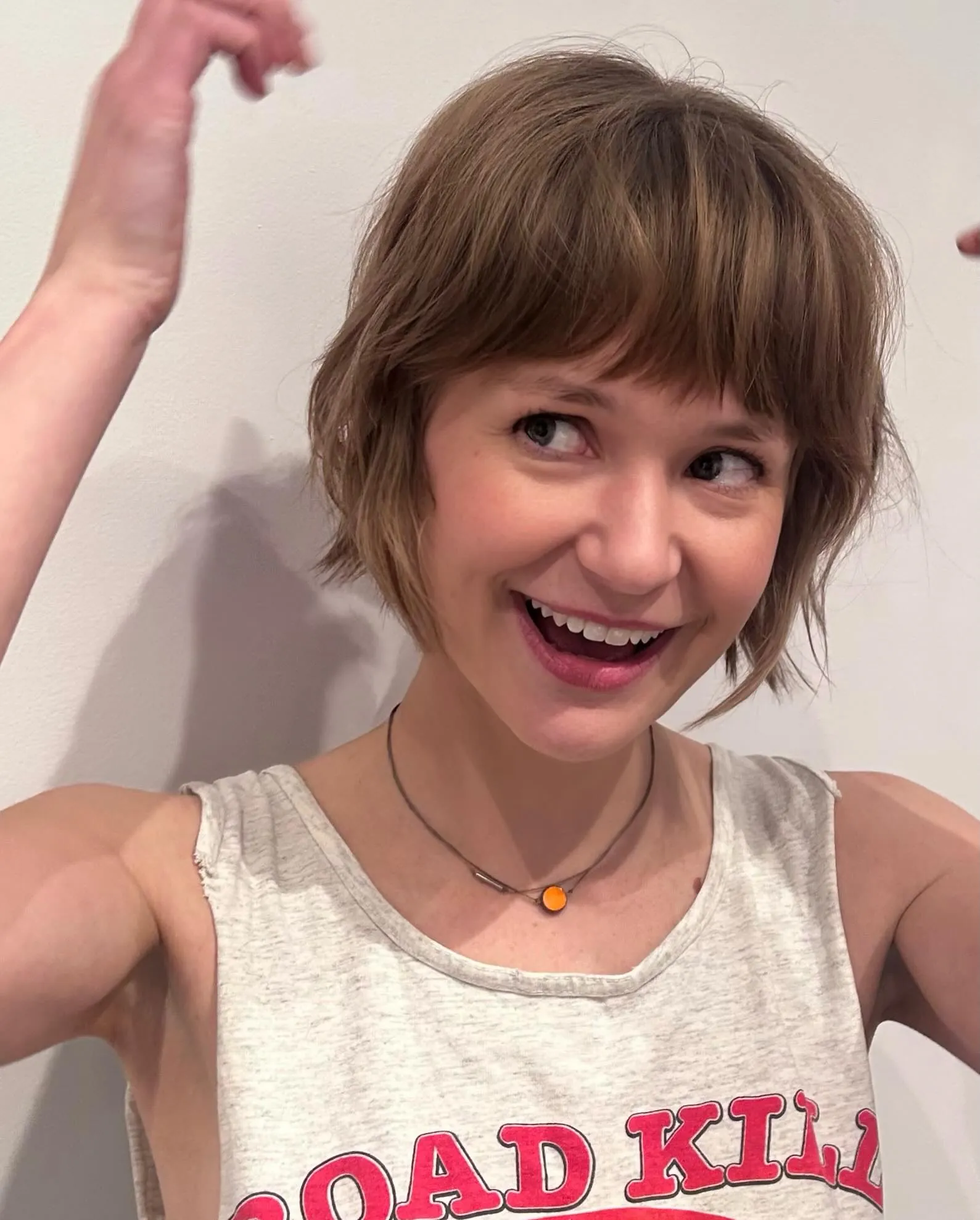 Soft light brown bixie with full brow-length bangs