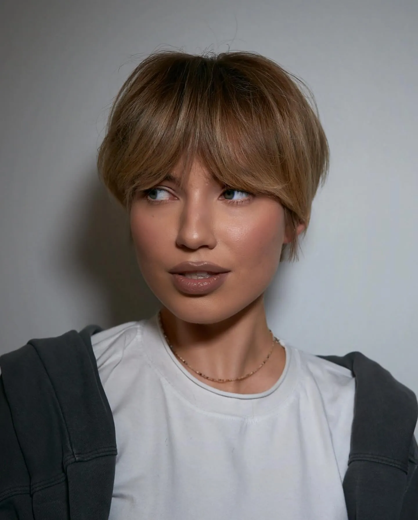 Light brown bixie with long center-parted curtain fringe