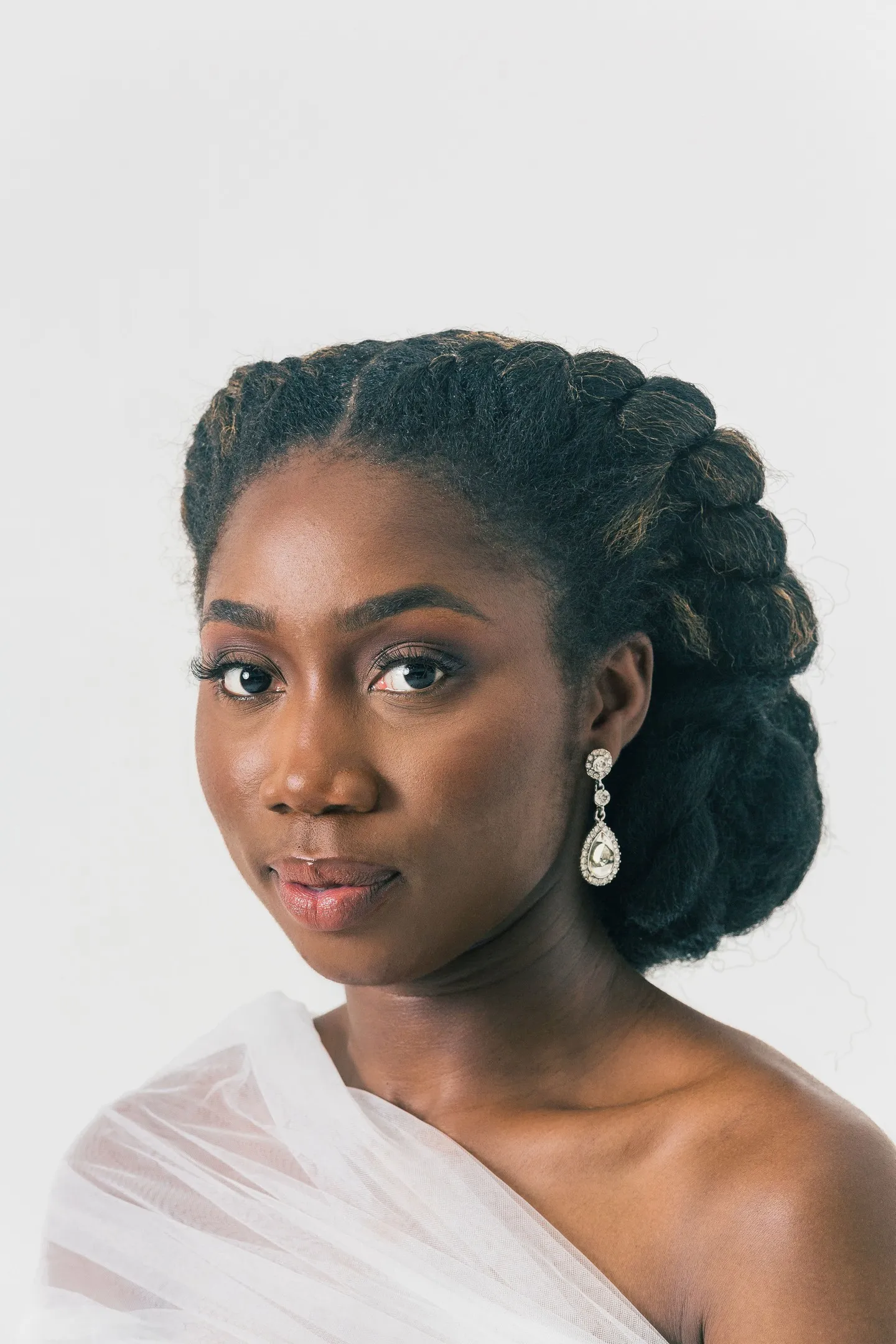 Natural bridal hairstyle with large twists gathered into a side bun