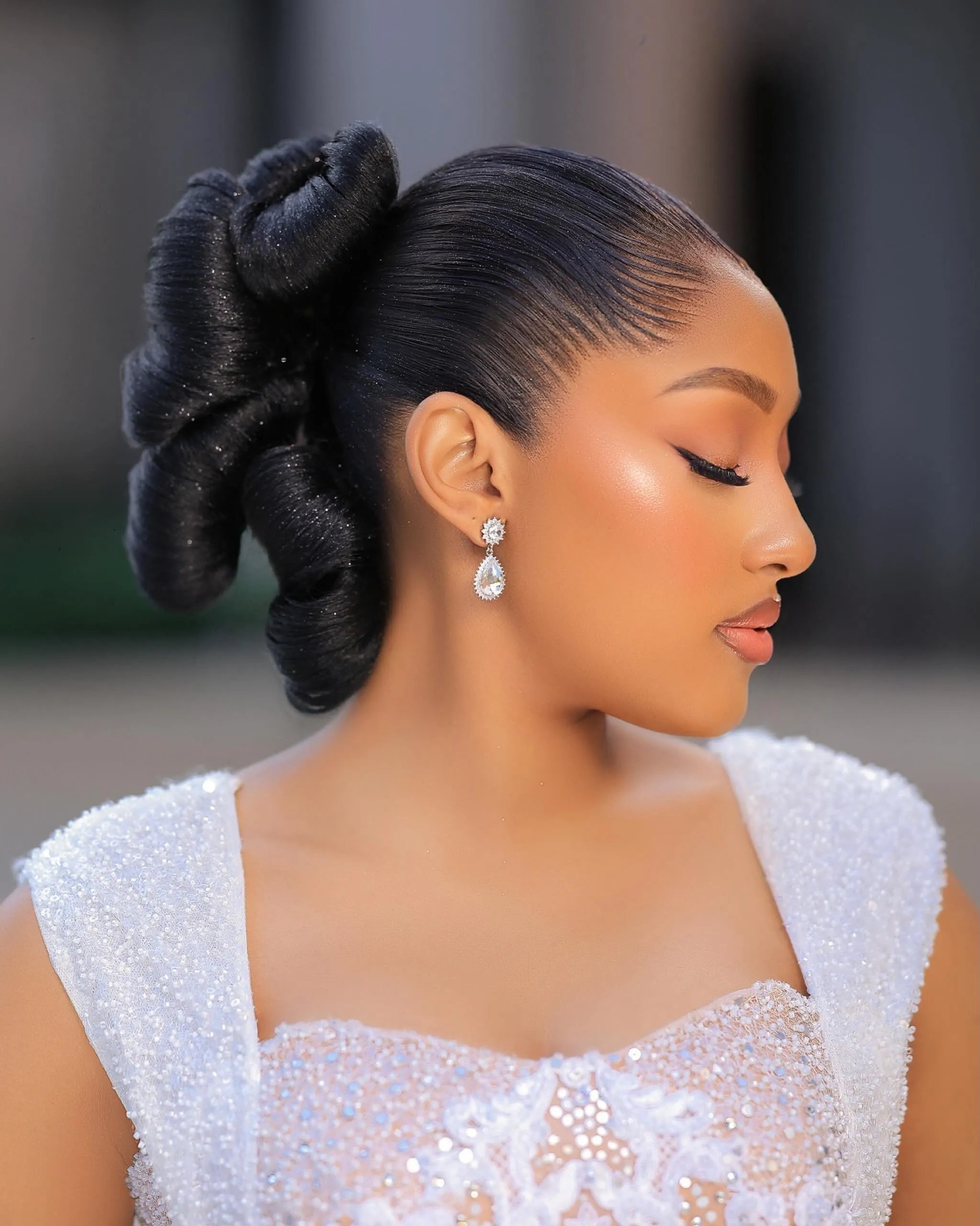 Sleek bridal bun with rounded sculpted rolls at the back