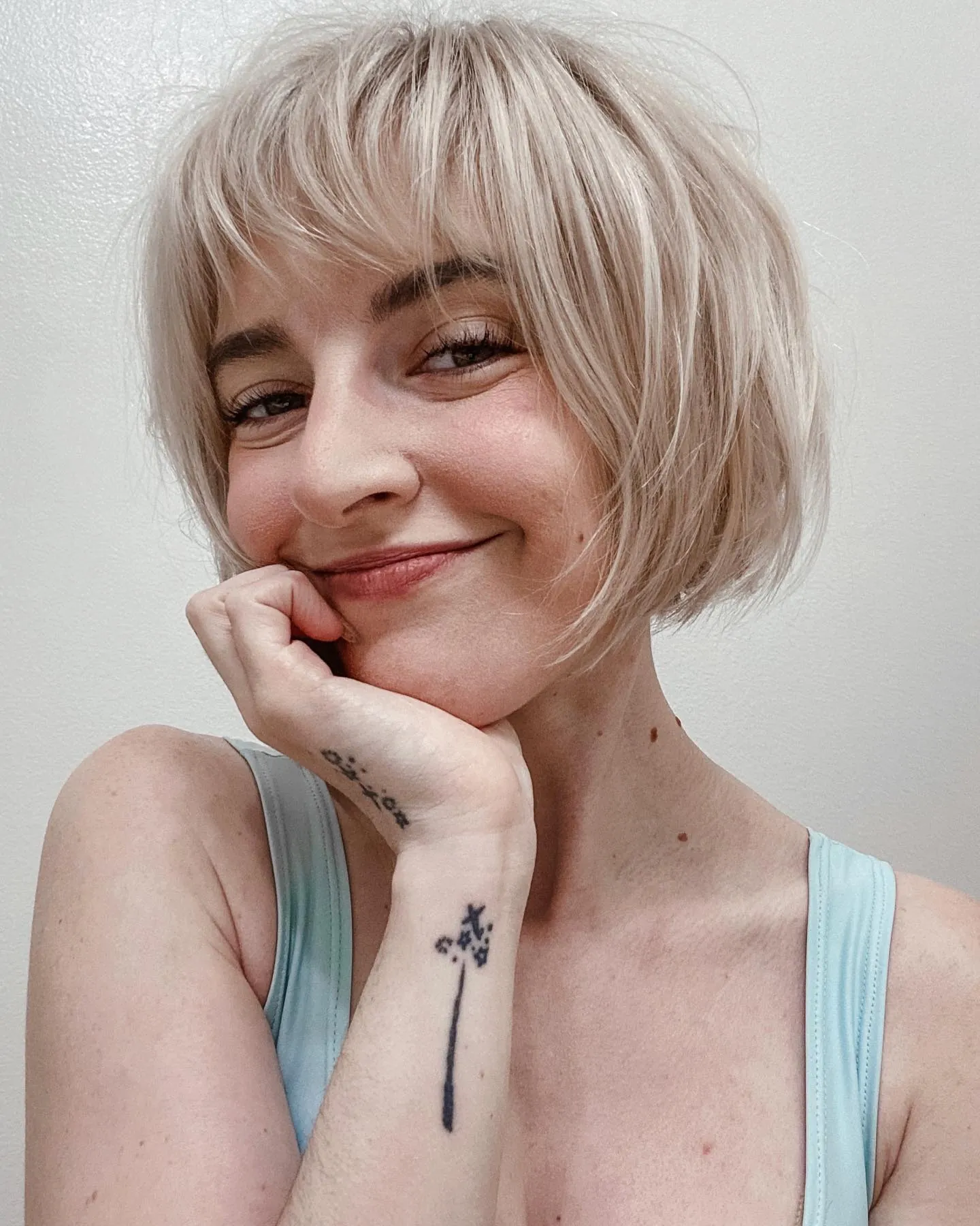 Short blonde bob with wispy fringe and rounded ends