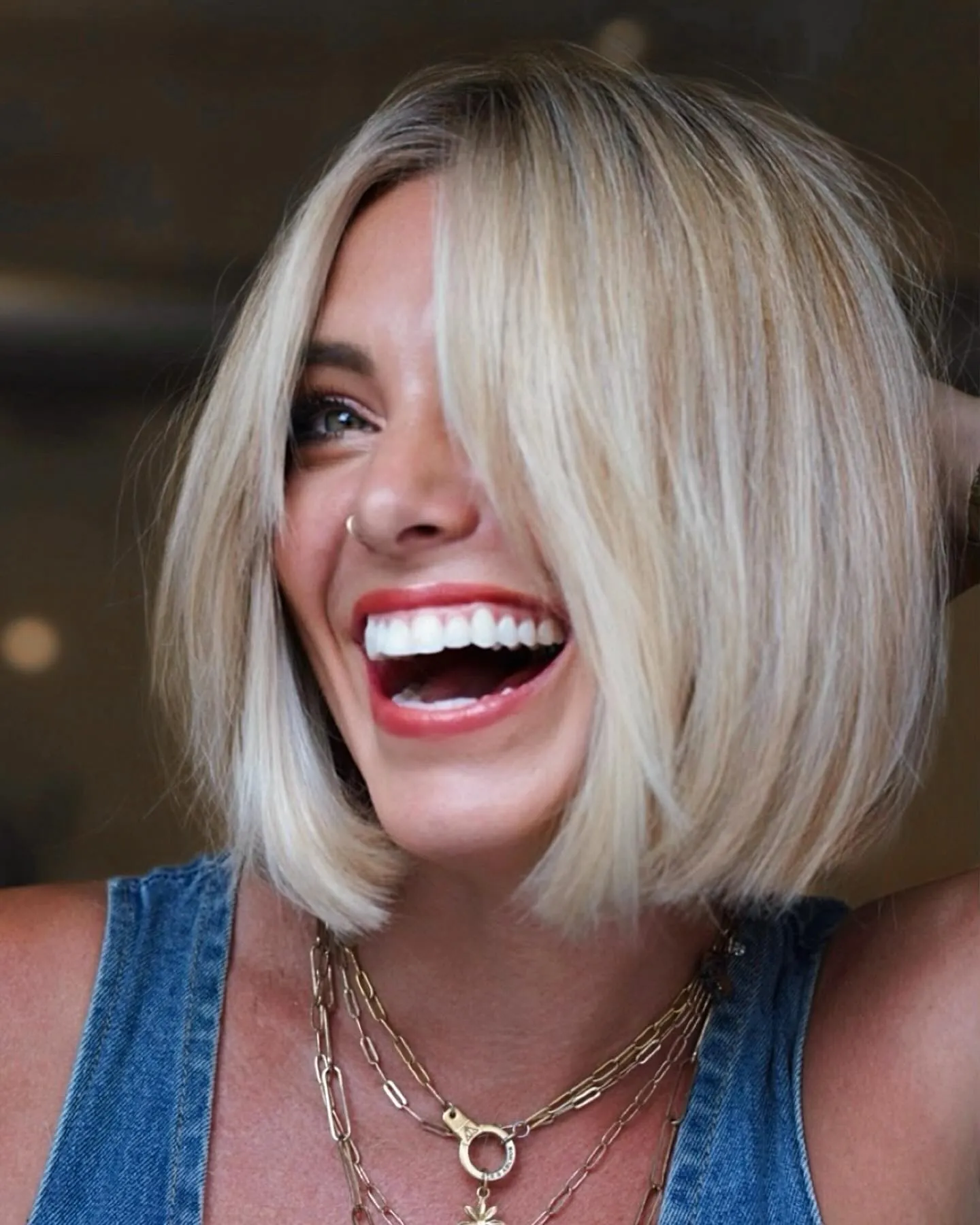 Blunt chin-length blonde bob with center part