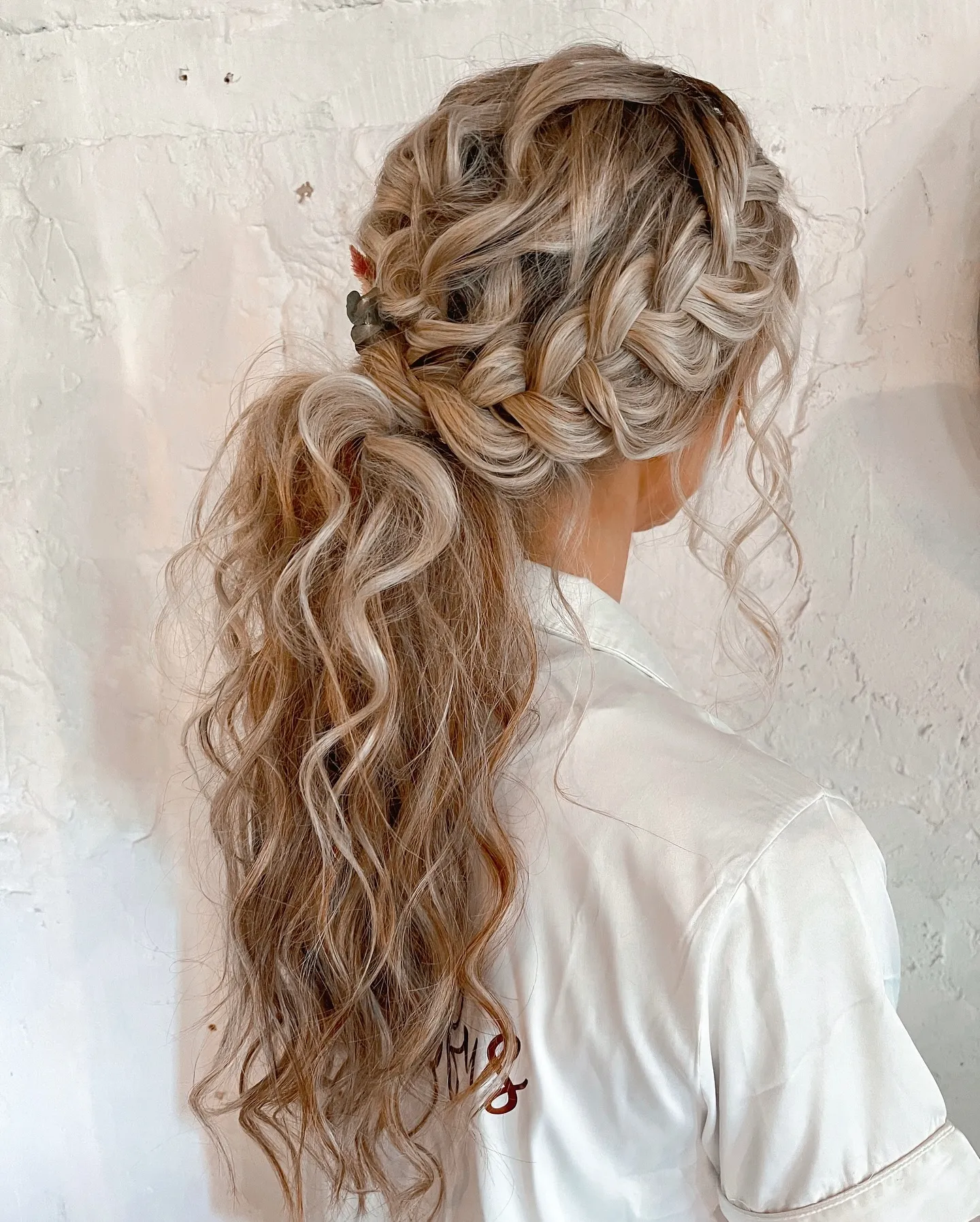 Double side braids with a low wavy boho bridal ponytail