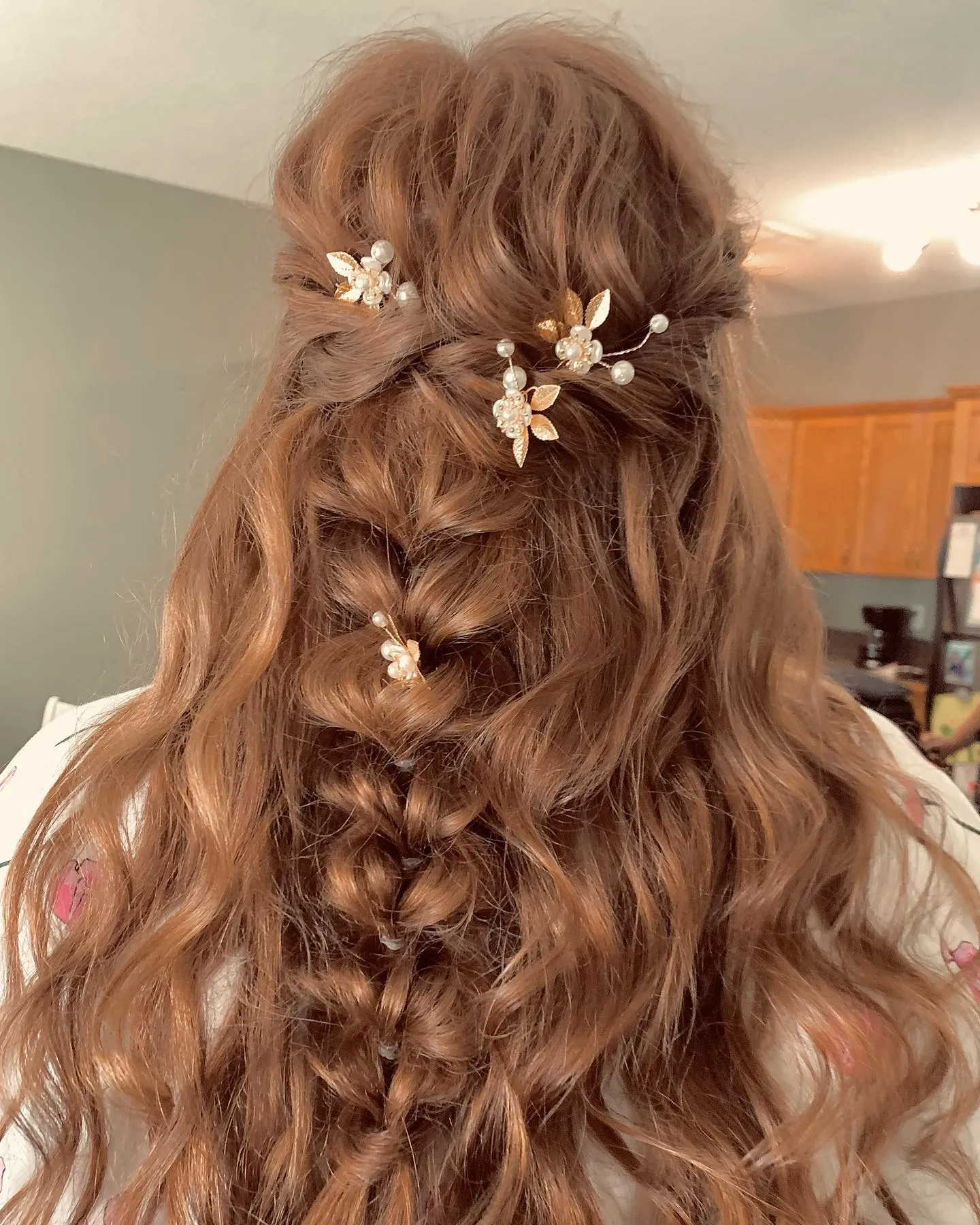 Loose centre braid with natural waves and gold floral bridal pins
