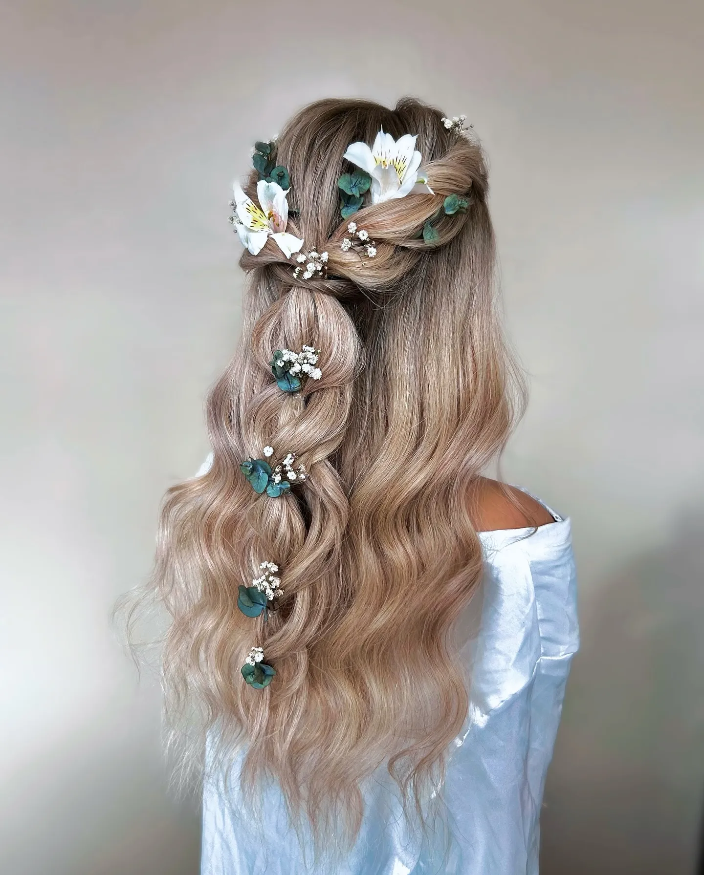 Long boho bridal waves with a twisted half-up style and turquoise floral details
