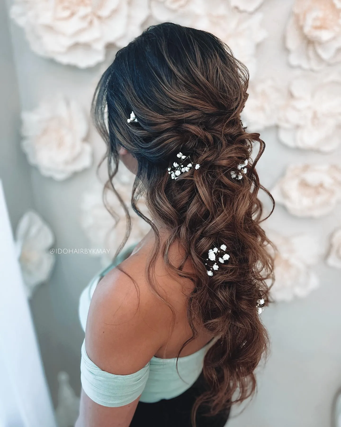 Low side bridal ponytail with loose curls and baby's breath