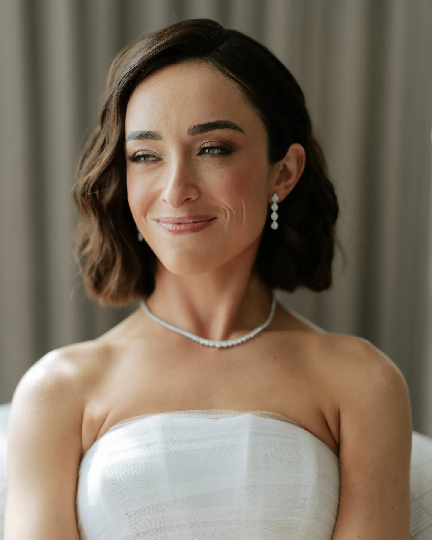 Polished side-parted bridal bob with soft sculpted waves