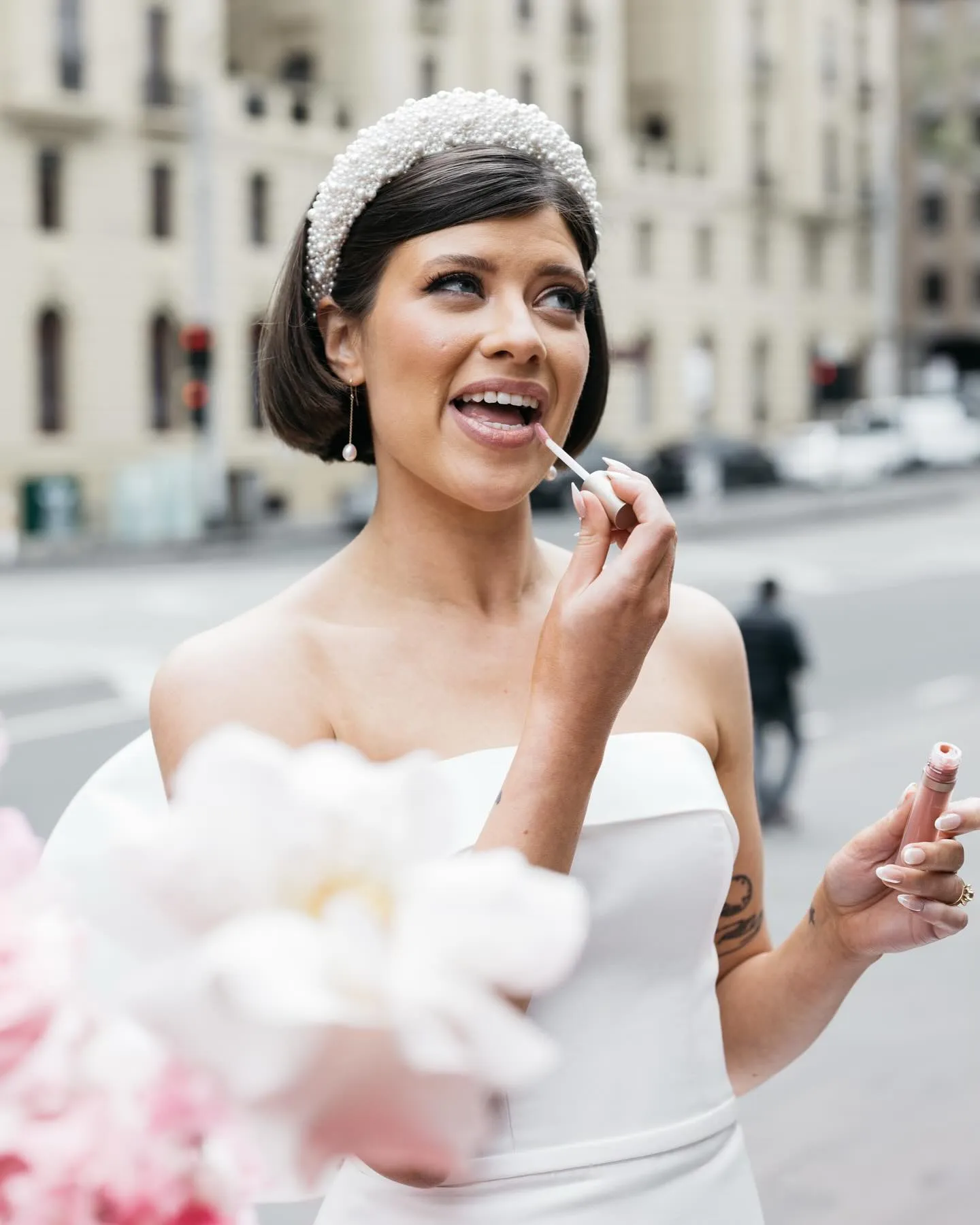 Sleek tucked bridal bob with side part and wide beaded headband