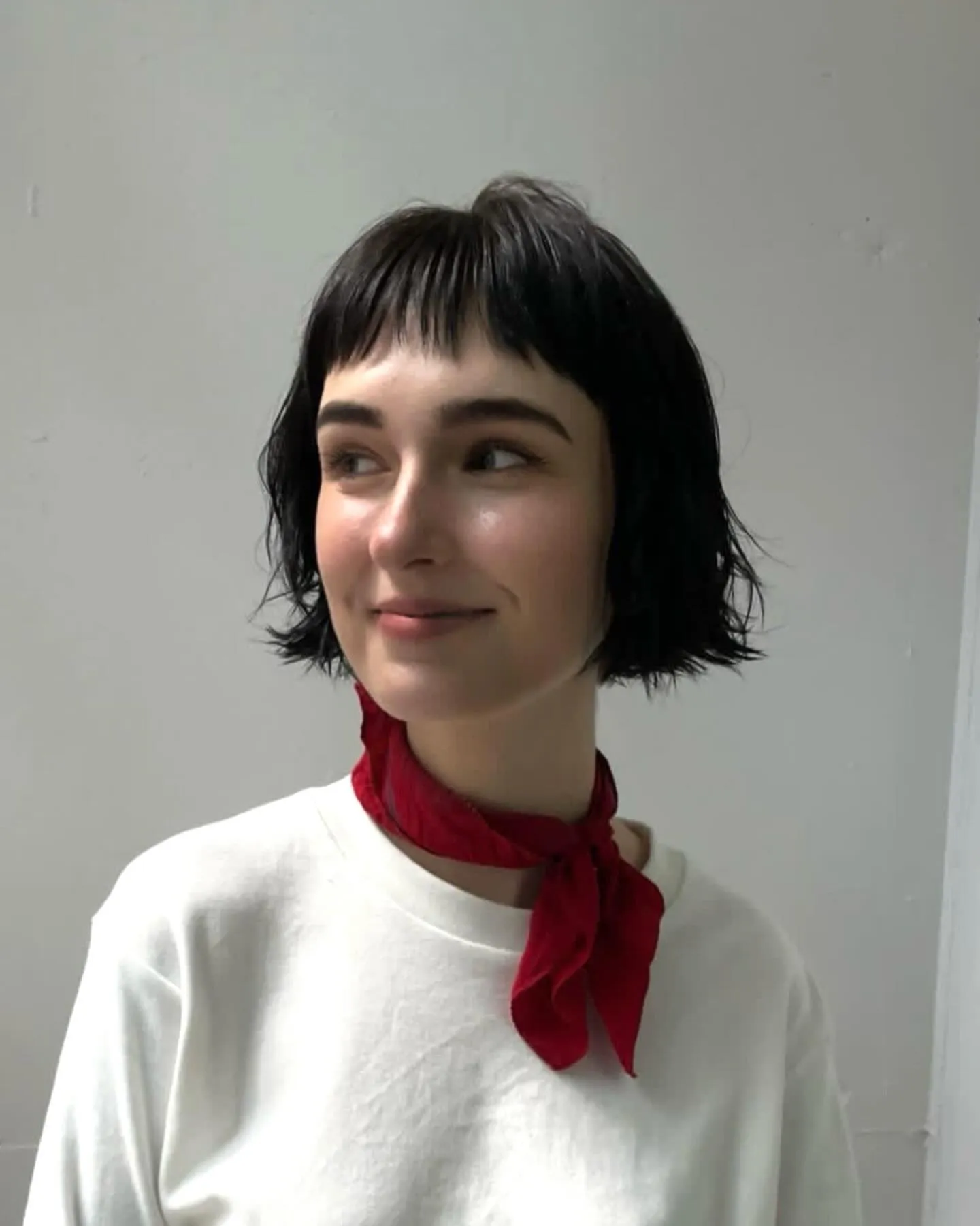 Choppy chin-length bridal bob with baby fringe and flicked textured ends