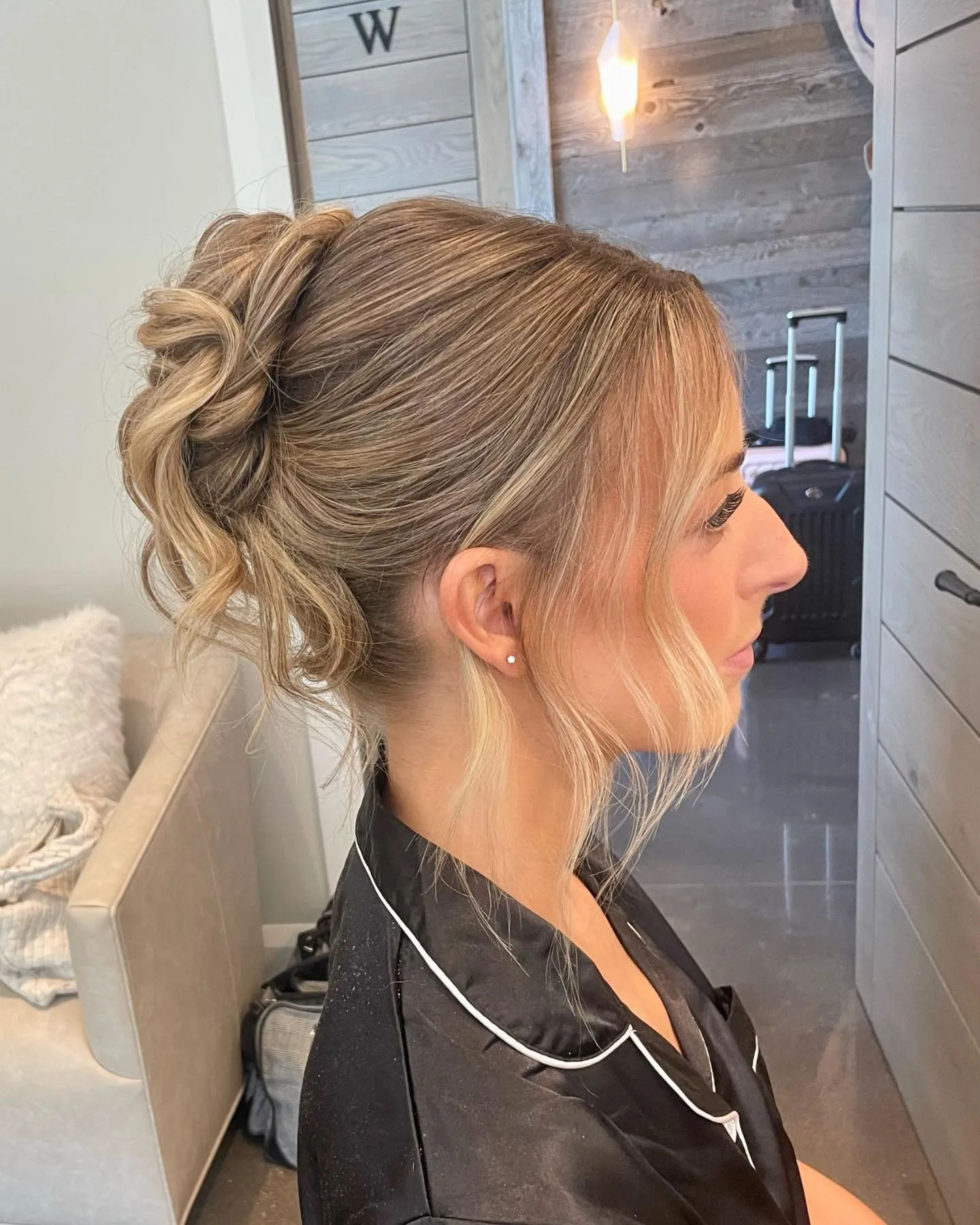 Relaxed mid-height bun with soft face-framing layers