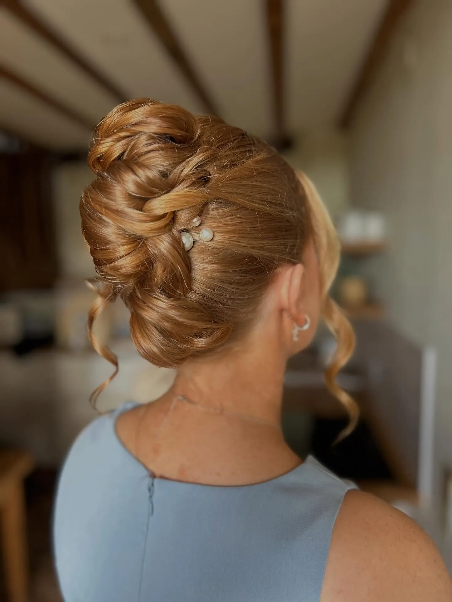 Polished twisted updo decorated with small pearl pins