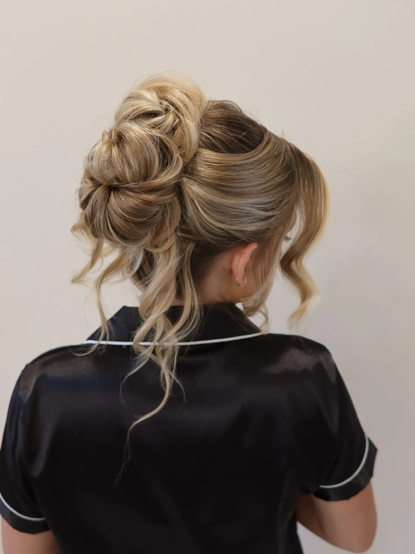 Voluminous curled bun with long loose tendrils