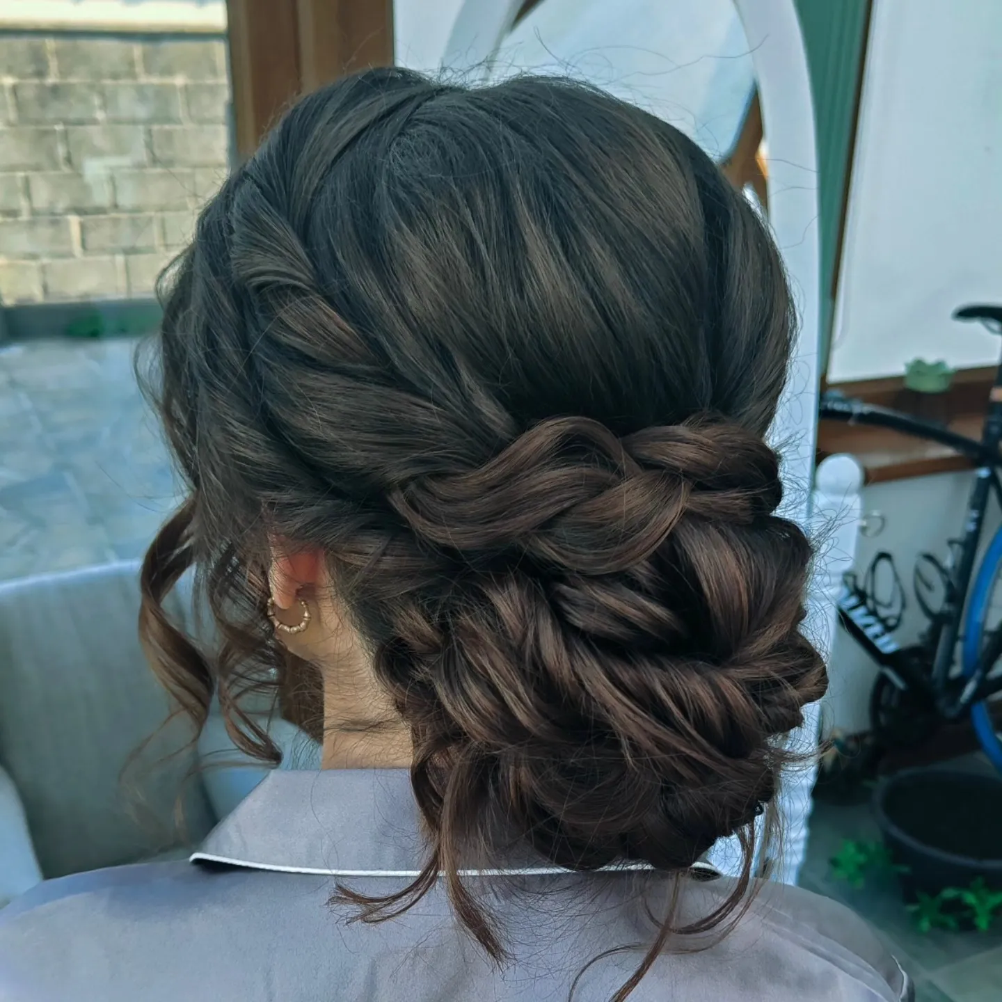 Twisted low bun with soft face-framing side pieces