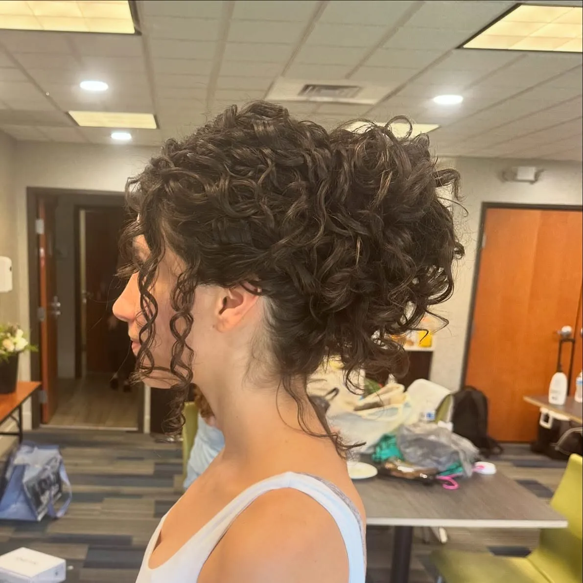 Curly high updo with defined ringlets and loose curls