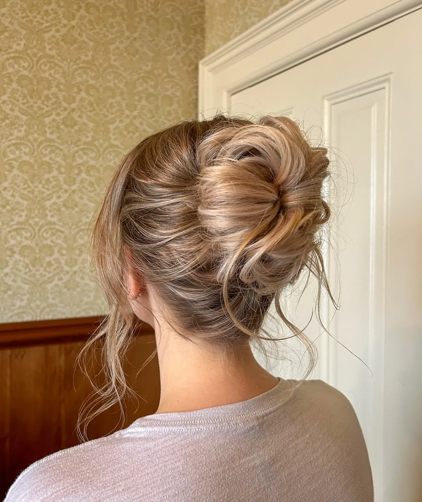 Soft twisted updo with draped sections and loose tendrils