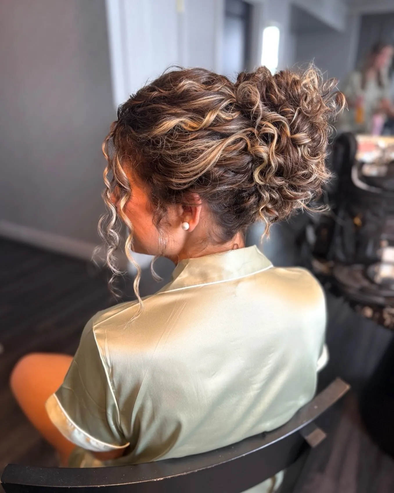 Curly braided updo with face-framing ringlets