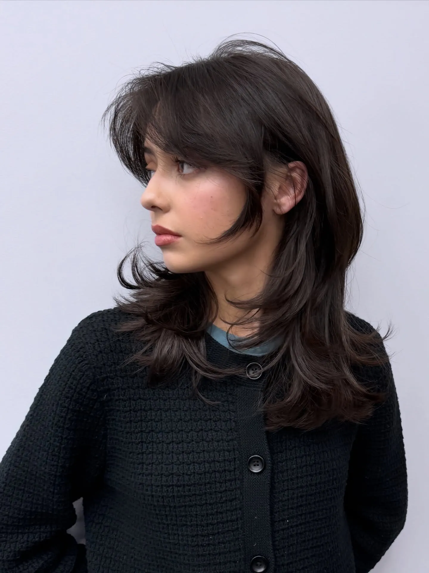 Dark butterfly haircut with long fringe and shaggy flipped layers