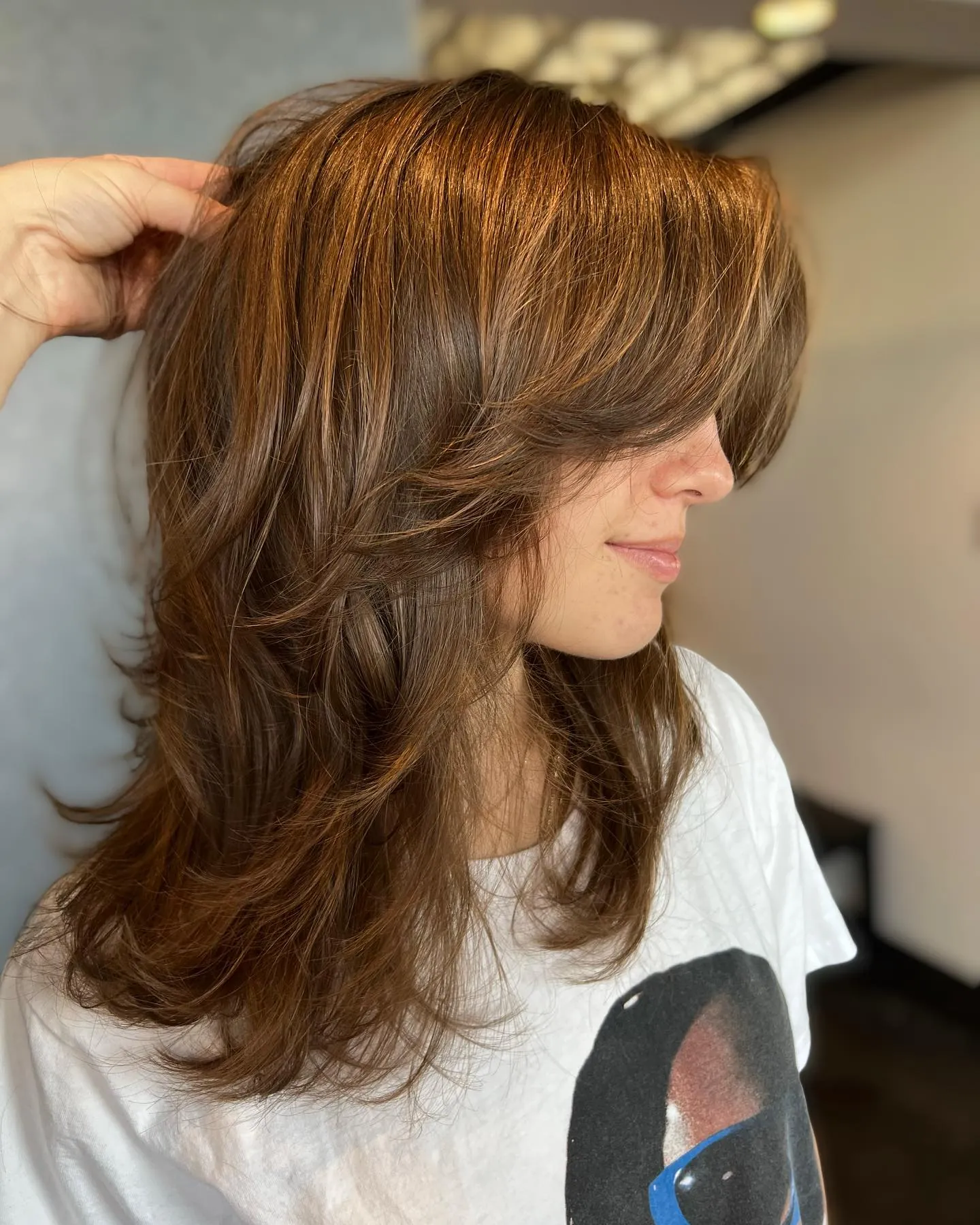 Brunette butterfly haircut with sweeping face-framing layers