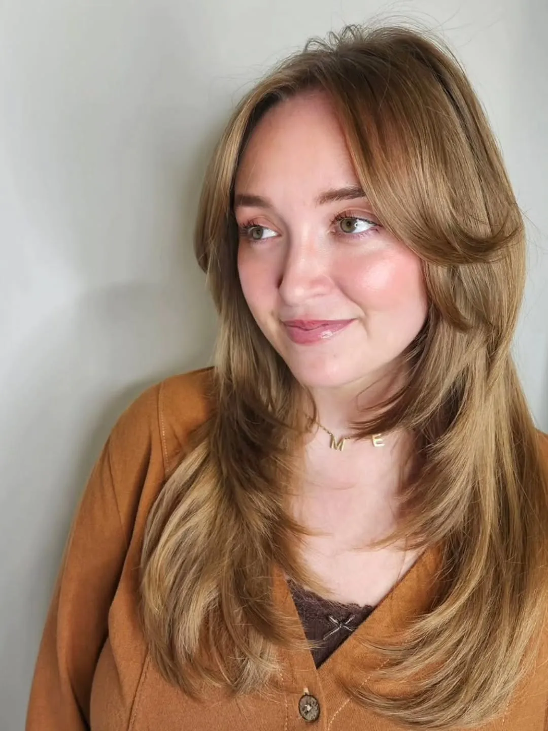 Long light brown butterfly haircut with soft curtain layers
