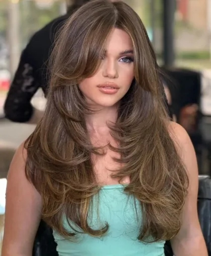 Long brunette butterfly haircut with full face-framing blowout