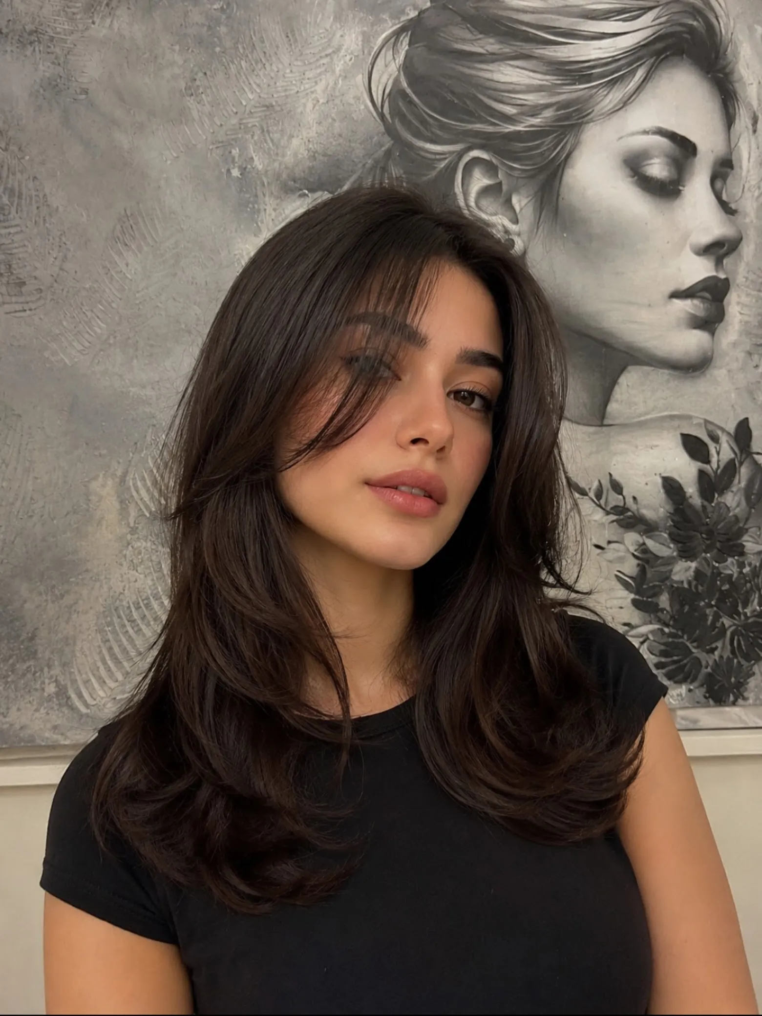 Long dark butterfly haircut with centre-parted curtain layers