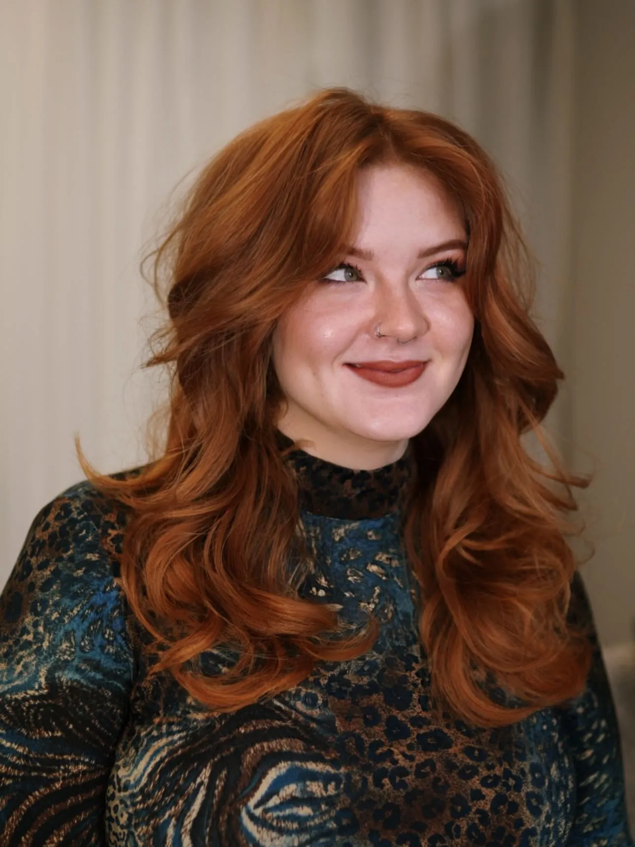 Copper butterfly haircut with loose waves and curtain fringe
