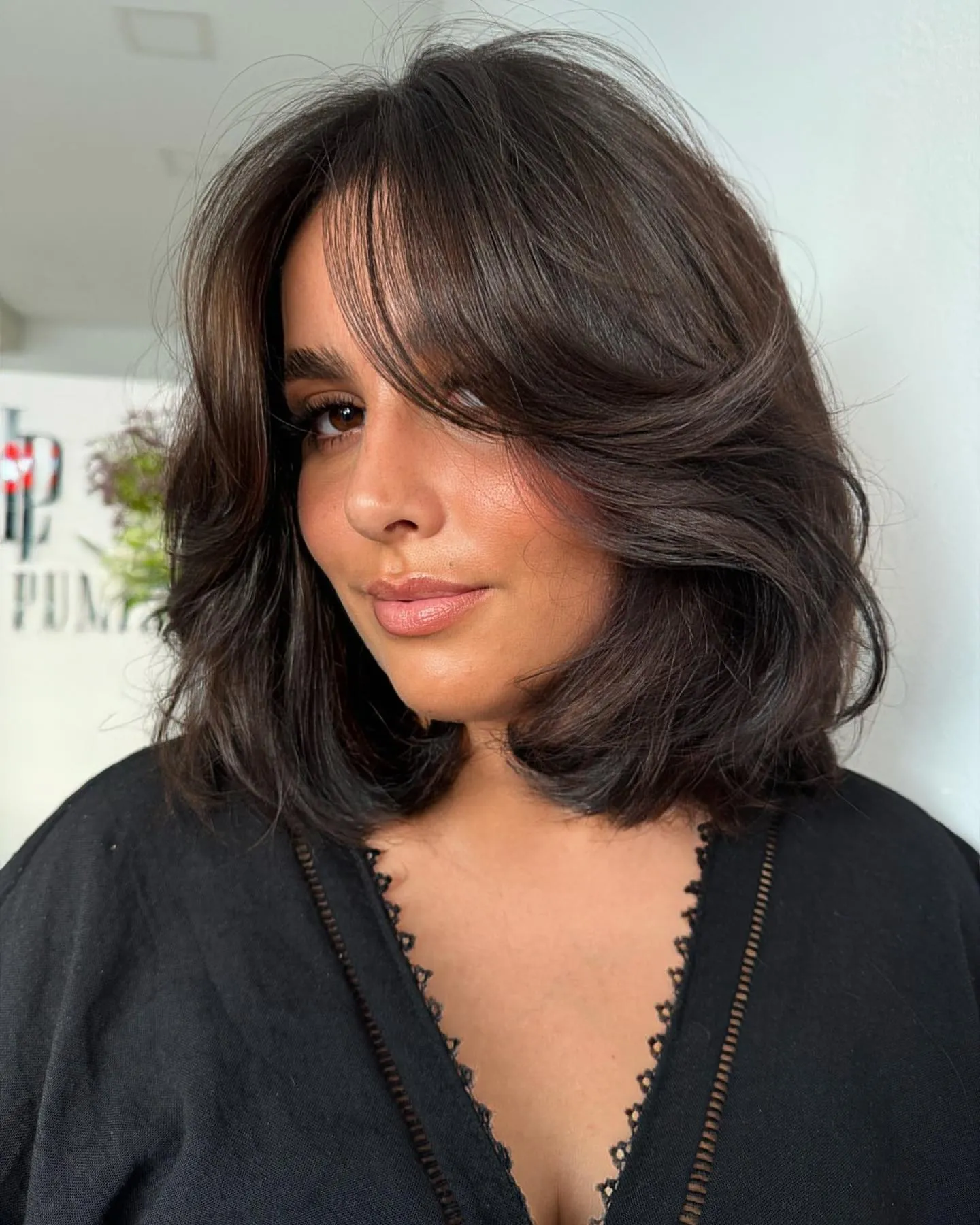 Dark brunette butterfly lob with rounded face-framing layers