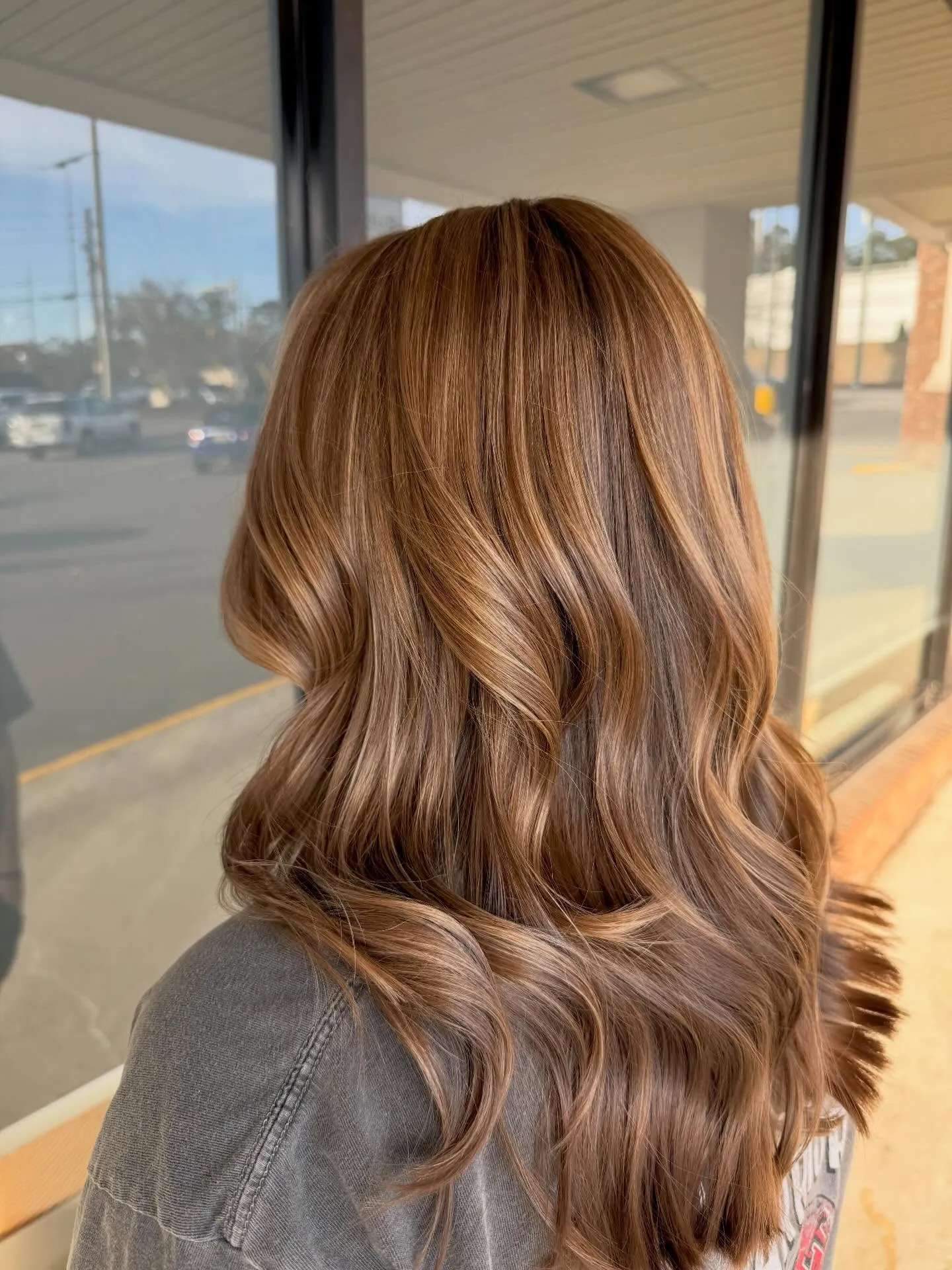 Medium brunette waves with warm blended balayage