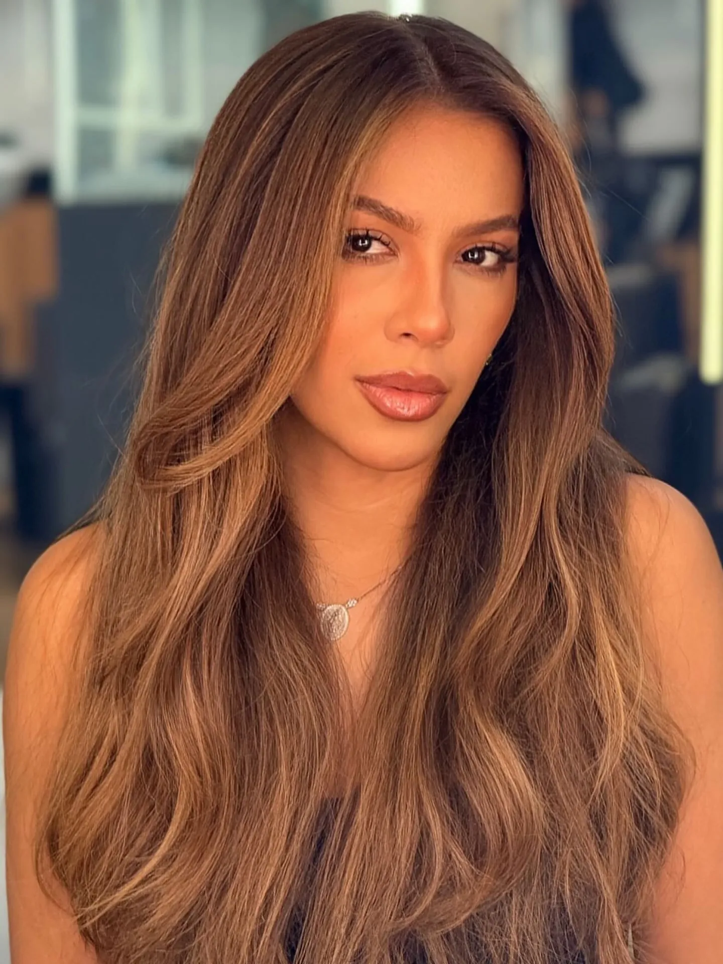 Long warm brown hair with a soft lighter face frame