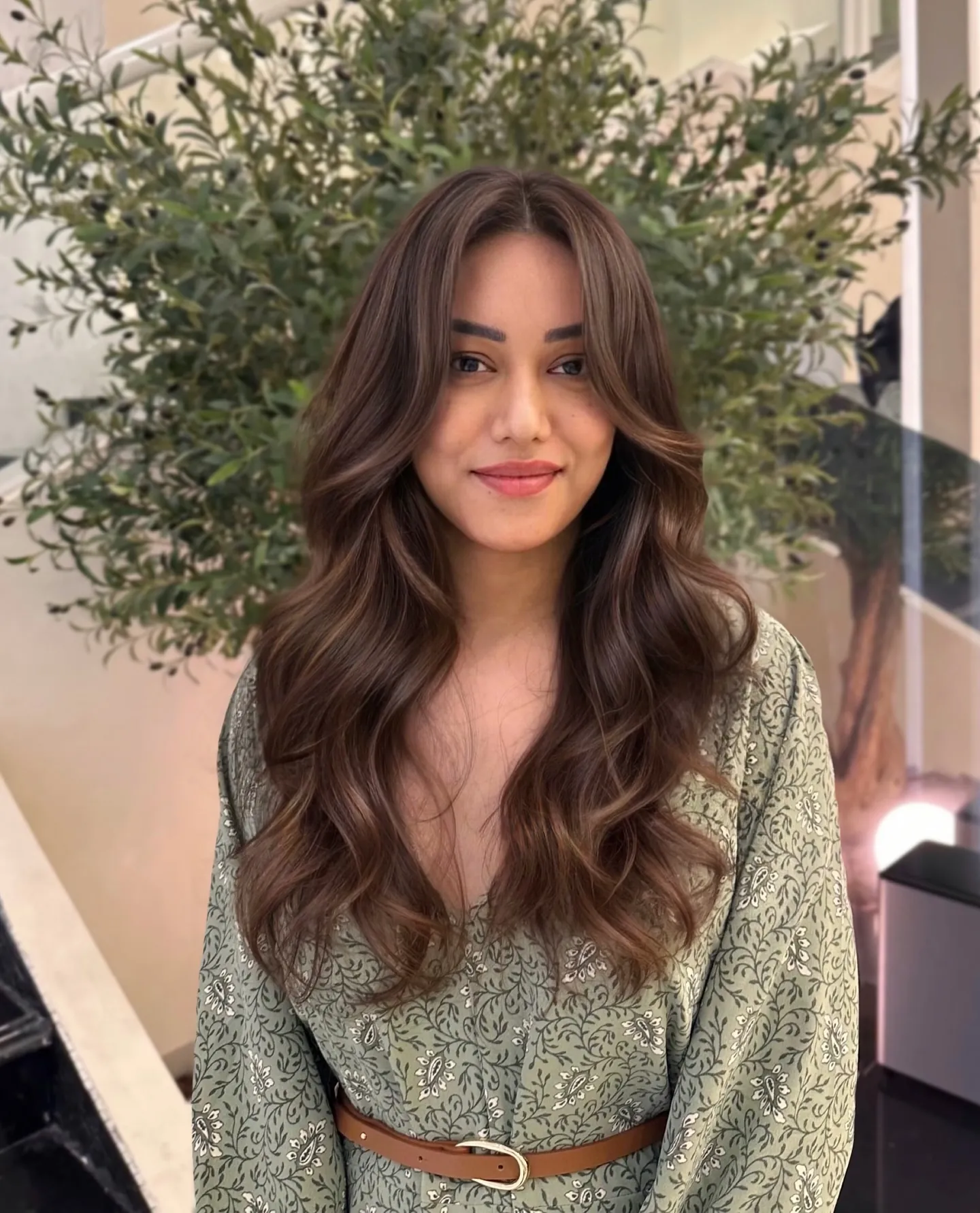 Long warm brunette layers with subtle blended highlights
