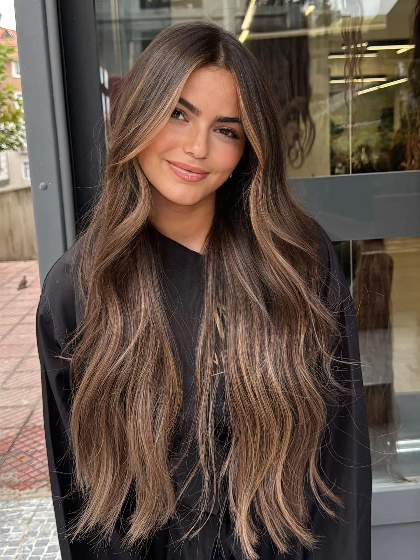 Very long brunette hair with warm ribbon balayage