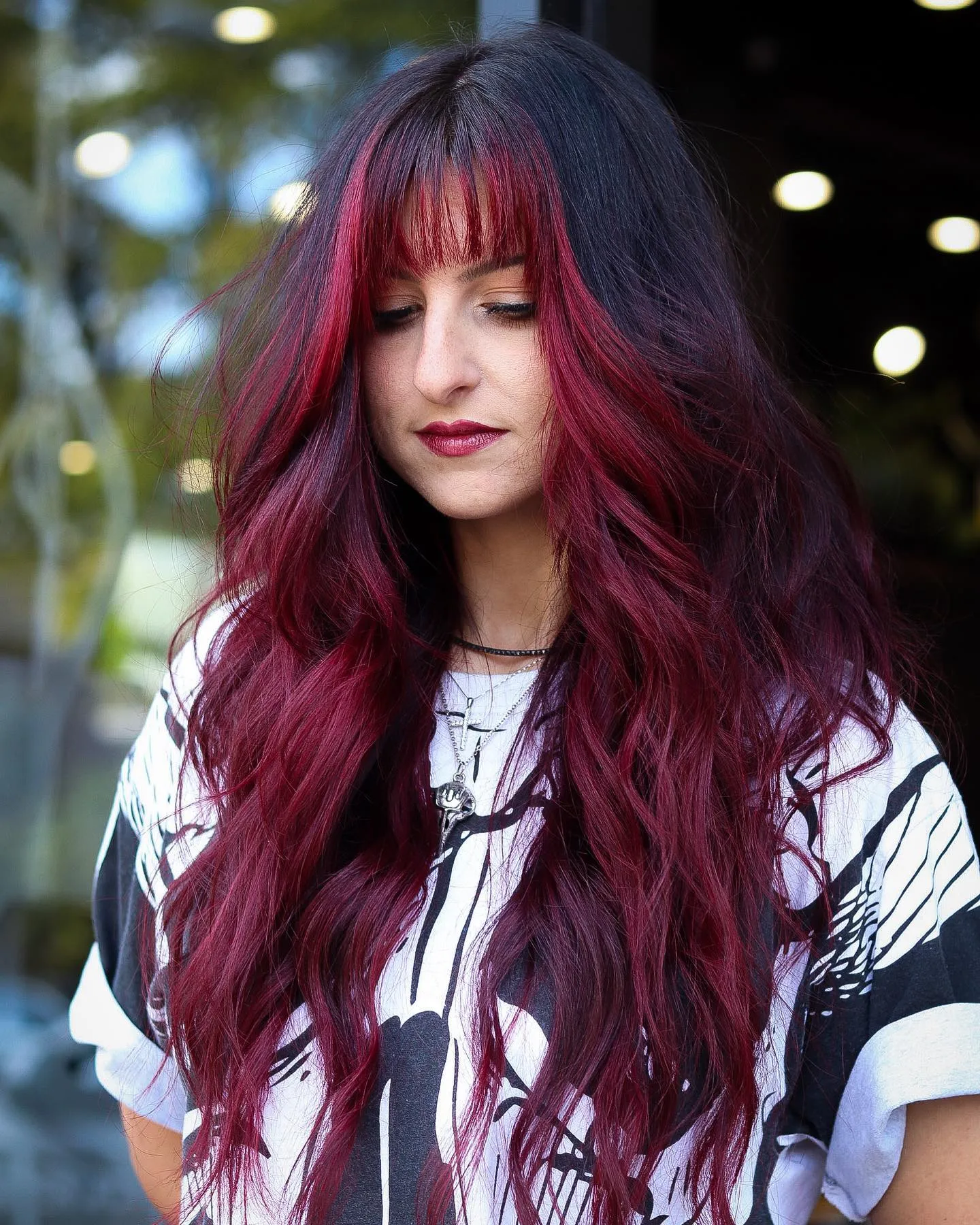 Long dark hair with vivid red panels and red fringe pieces