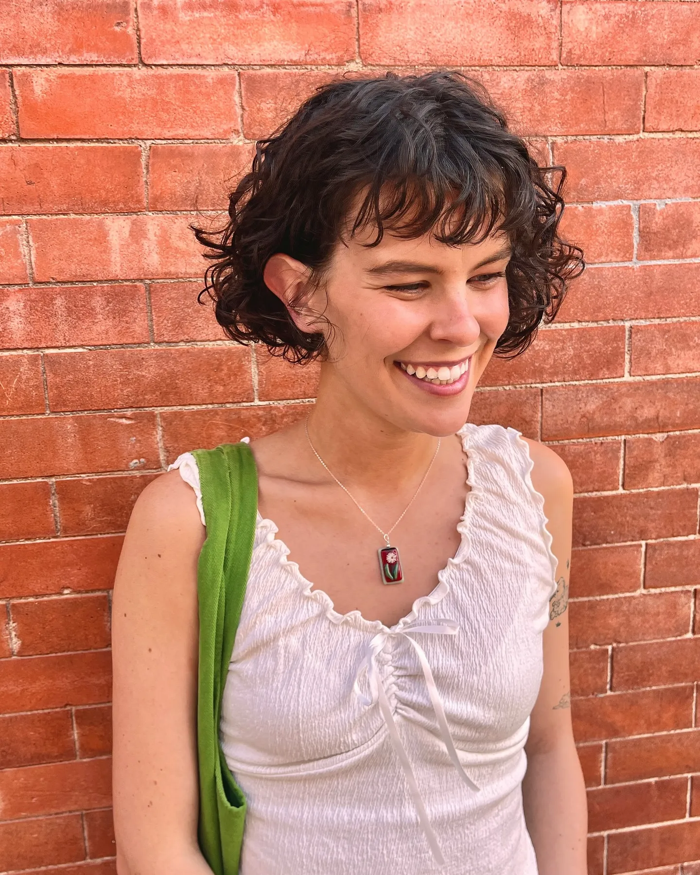 Curly dark chin-length bob with a short curled fringe