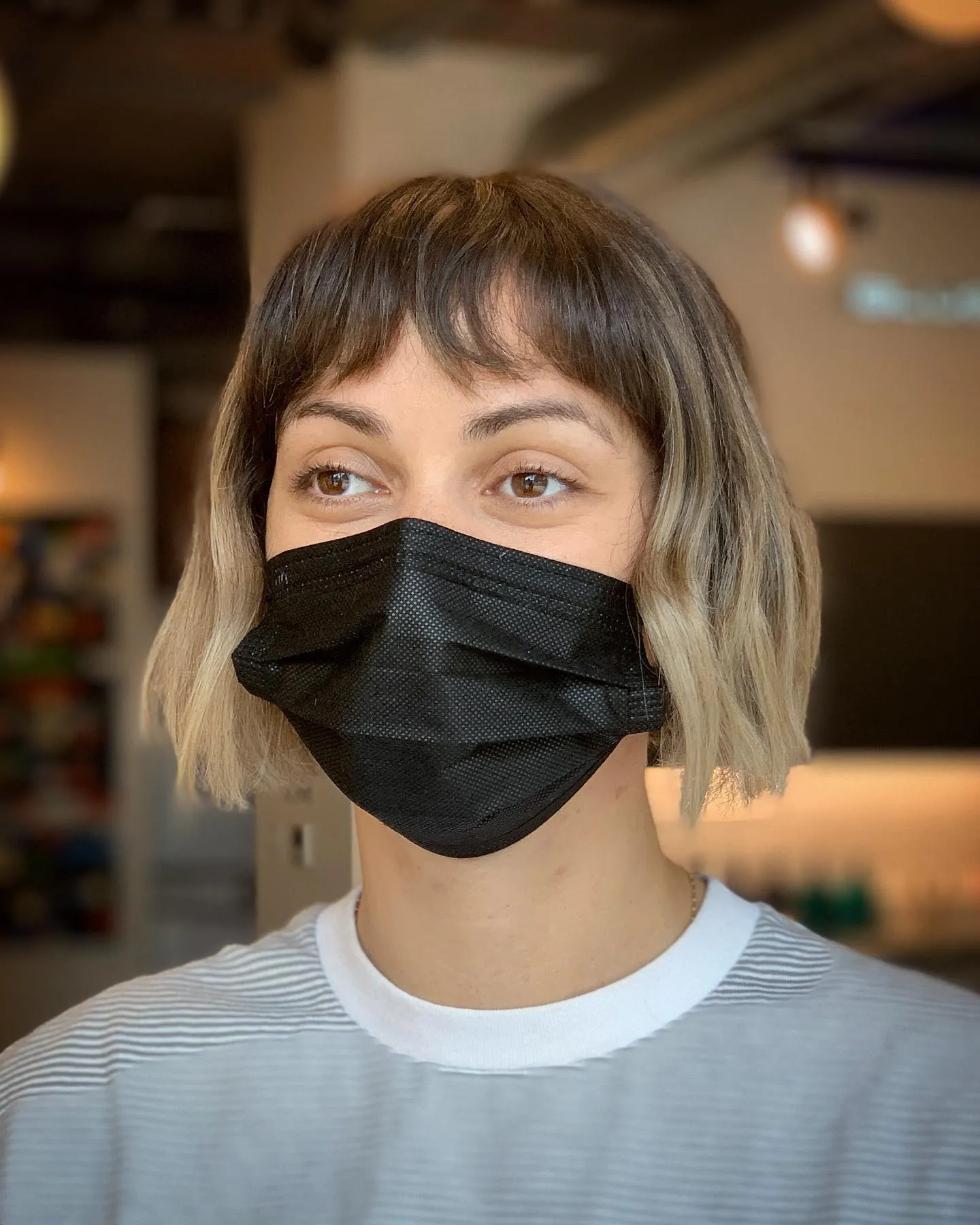 Choppy chin-length bob with dark roots, light ends and a wispy fringe
