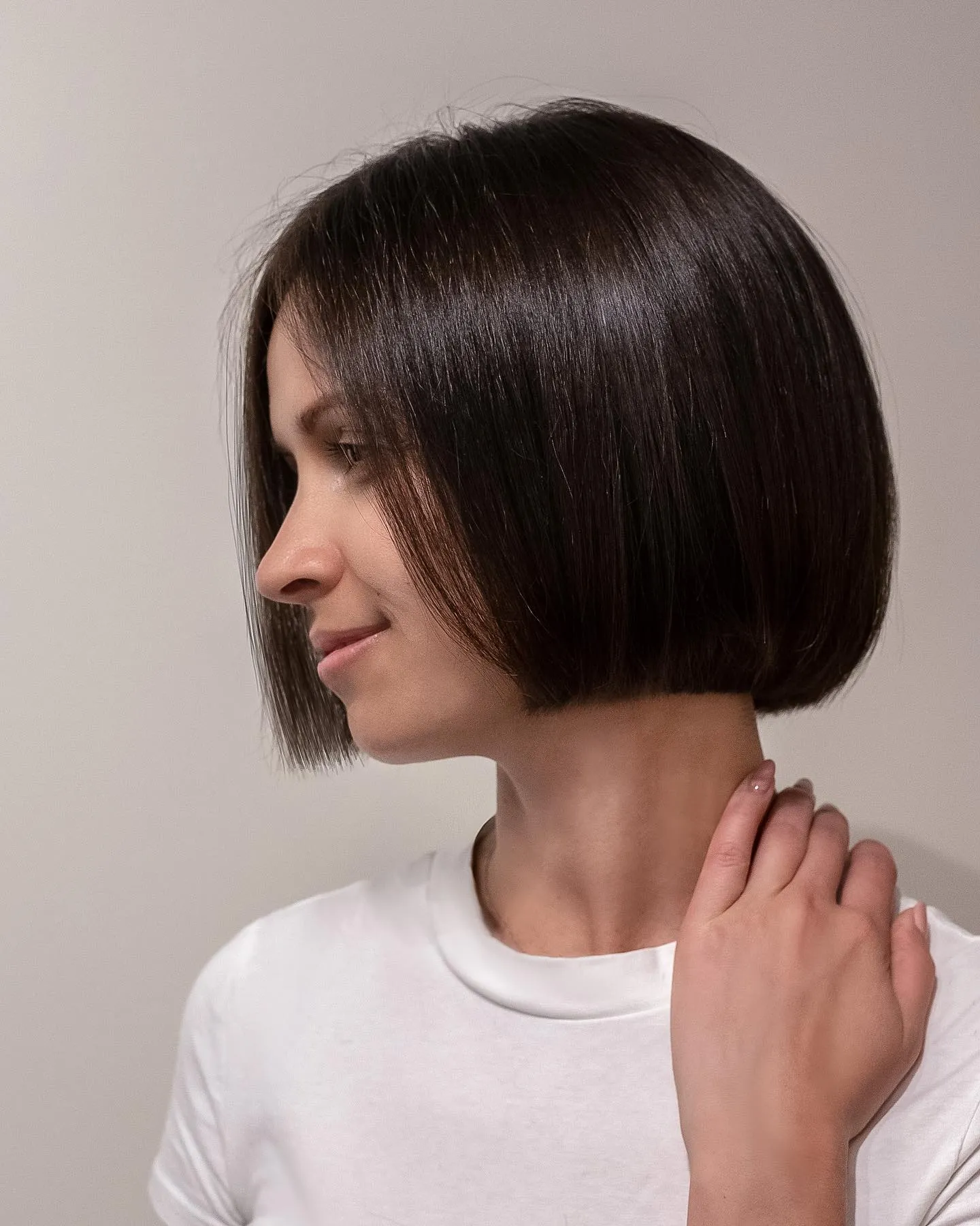 Sleek dark angled chin-length bob with a centre part
