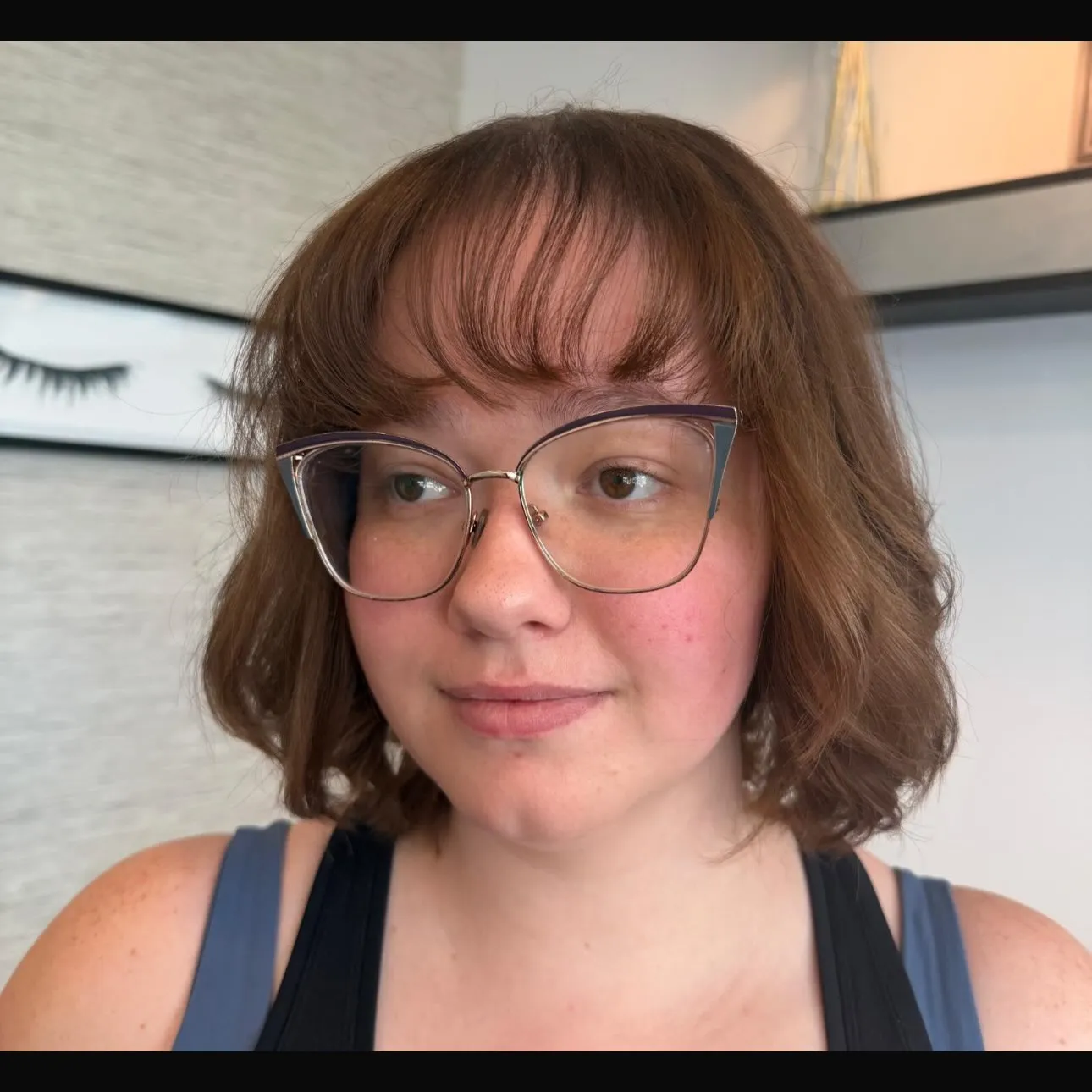 Soft auburn wavy chin-length bob with a rounded full fringe