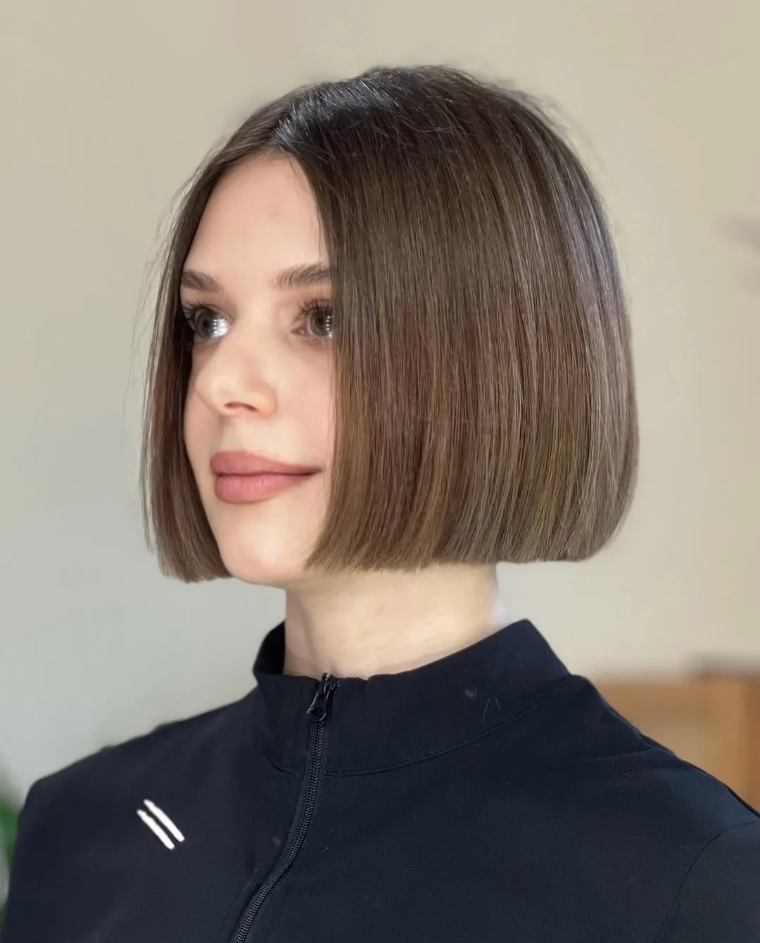 Sleek brown chin-length blunt bob with a centre part
