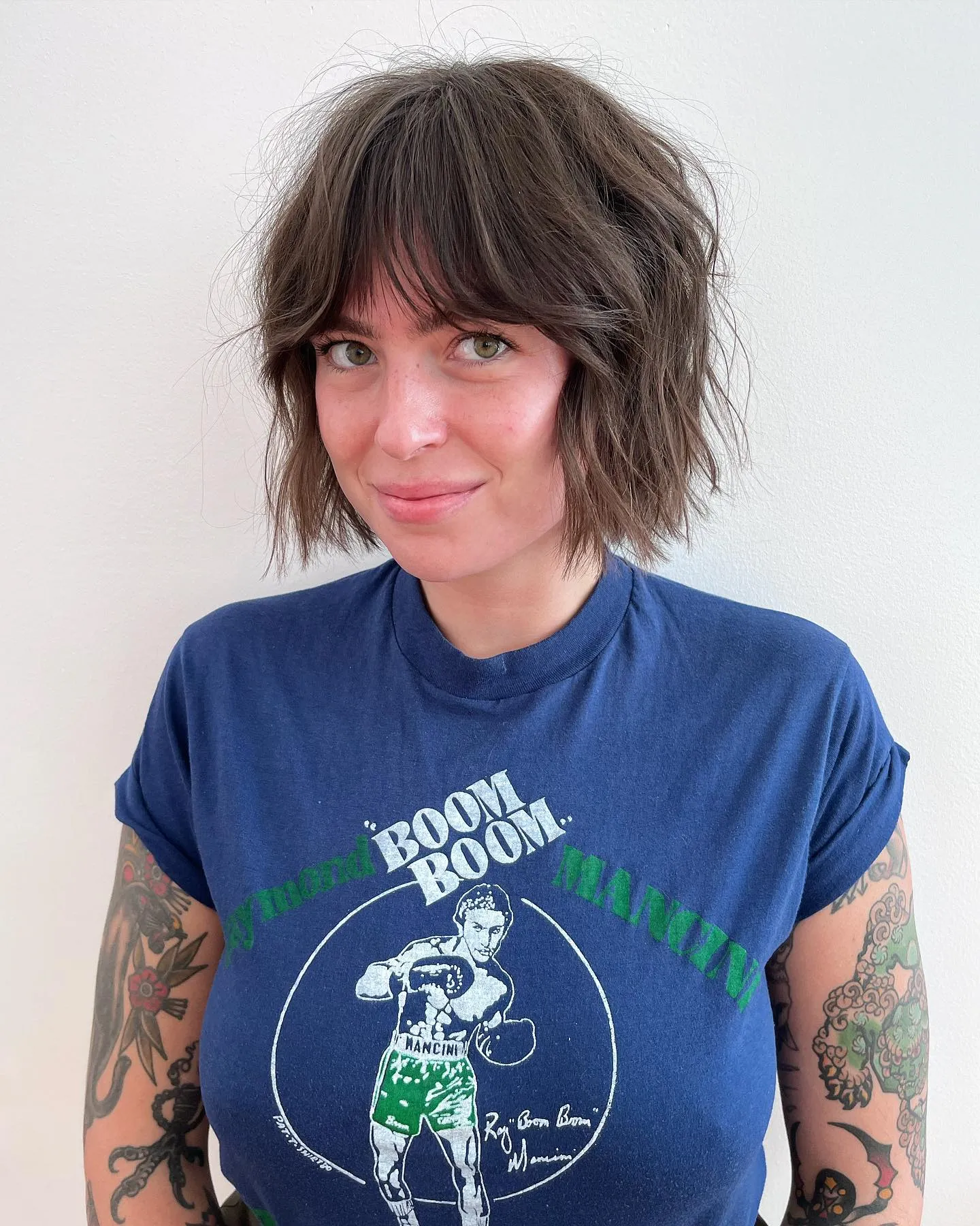 Shaggy brown chin-length bob with curtain fringe and tousled layers